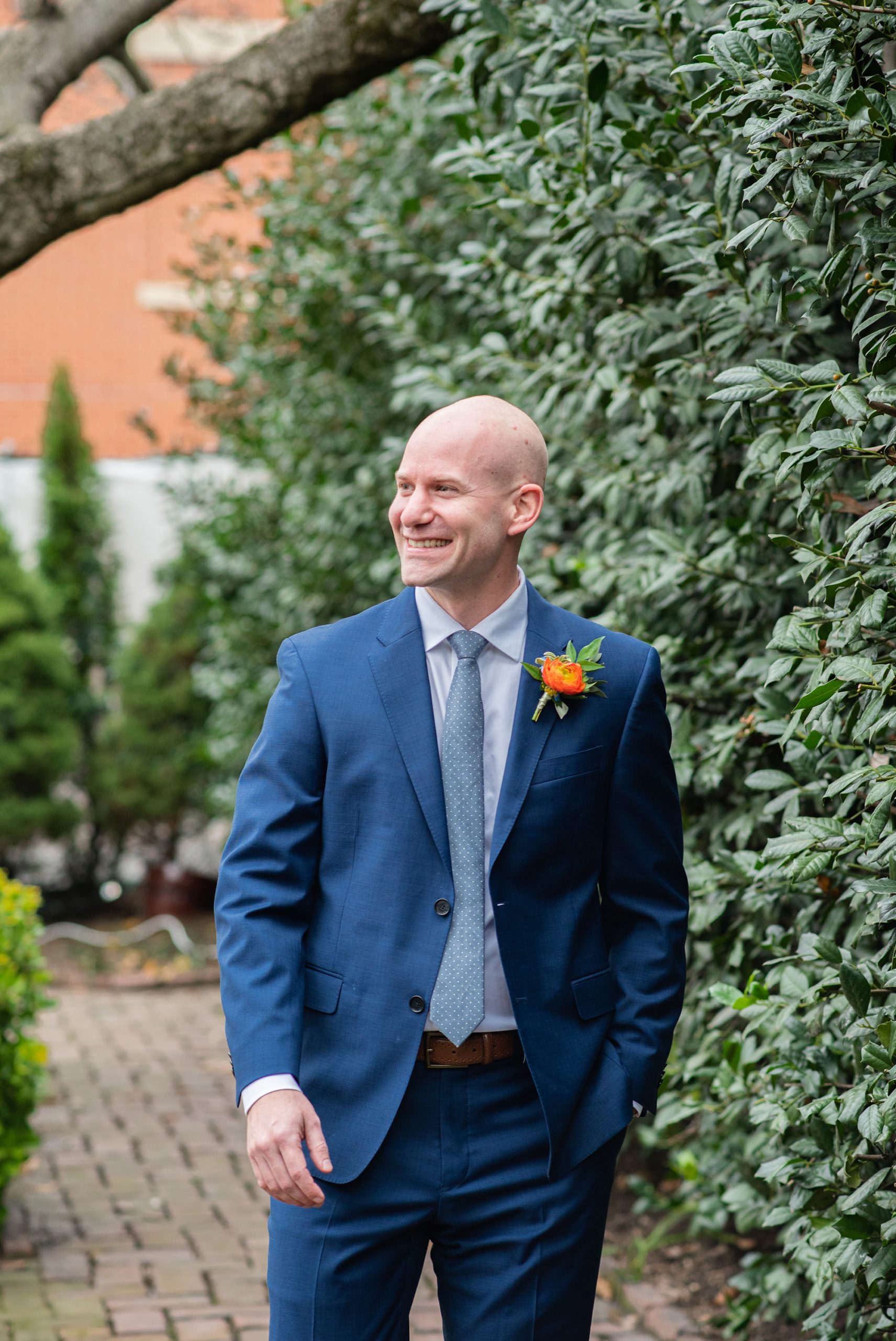 groom wears navy suit during Italian inspired microwedding
