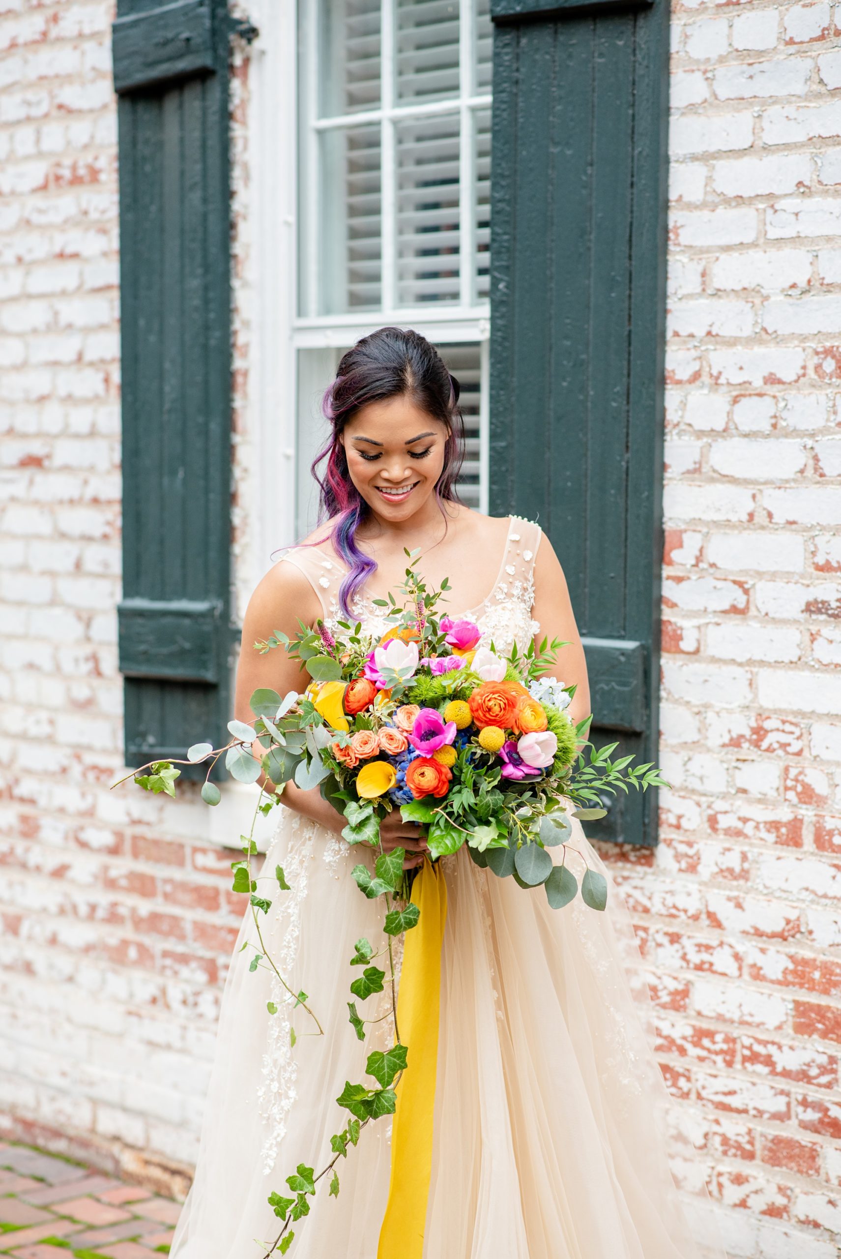 bride poses with bright bouquet during Italian inspired microwedding styled shoot