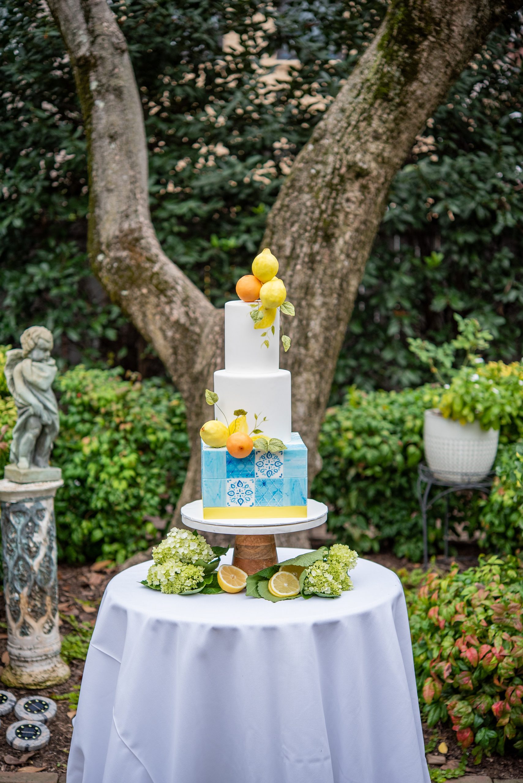 tiered wedding cake with blue geometric base and lemons