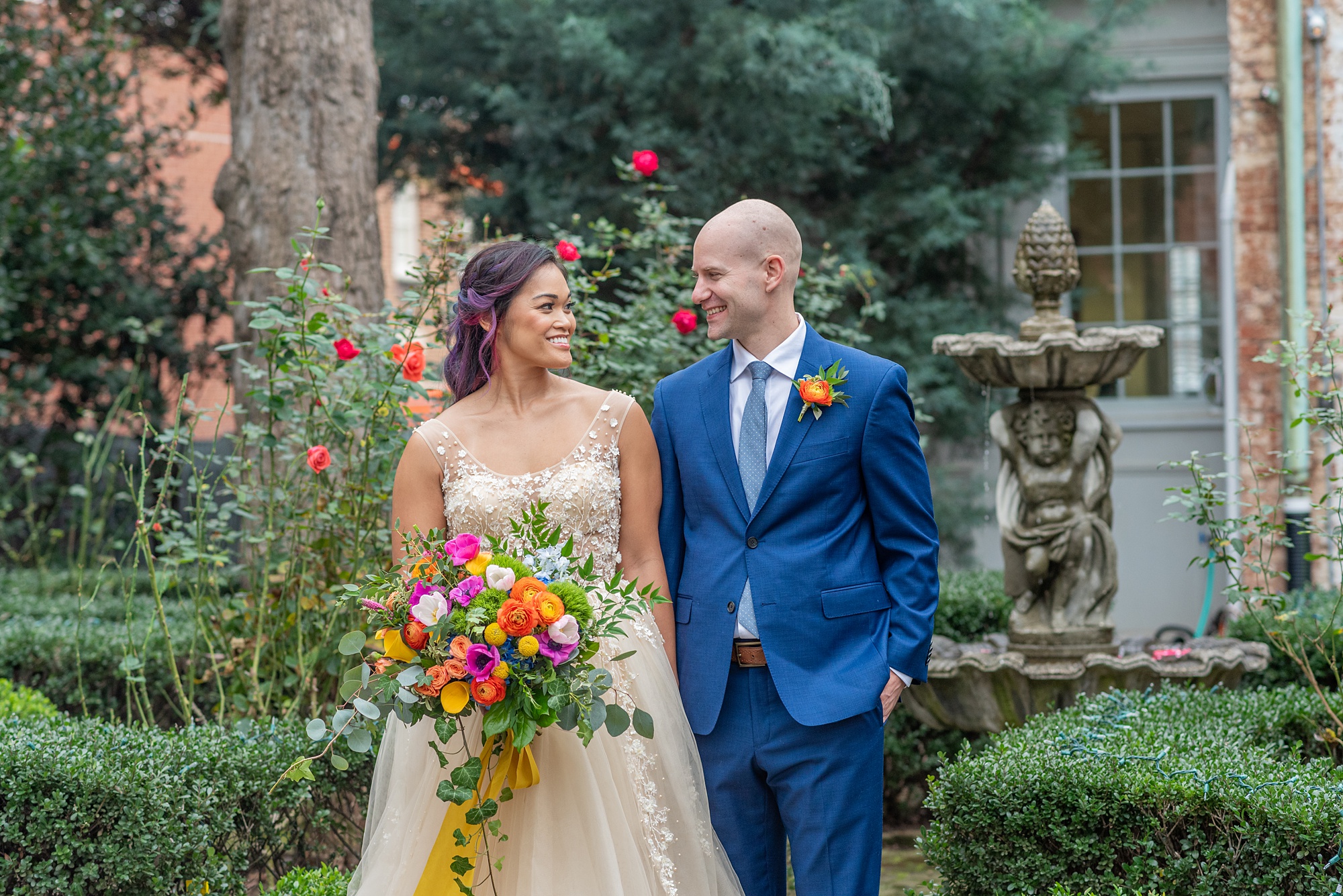 bride and groom walk through gardens of Old Town Alexandria Rectory
