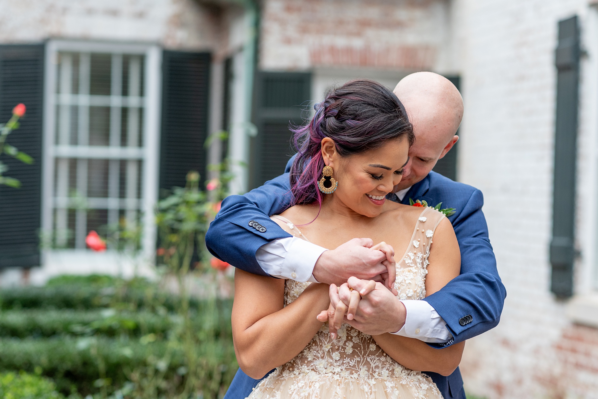 groom hugs bride from behind during Italian inspired microwedding styled shoot