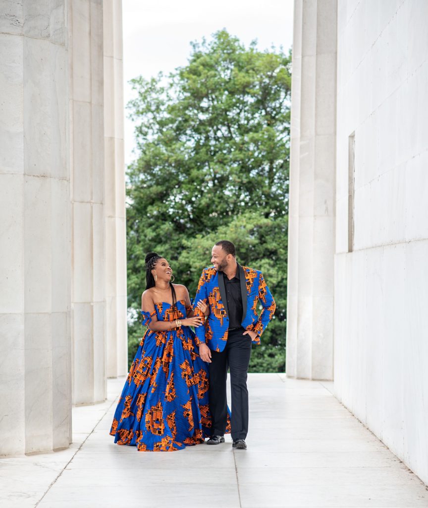 engaged couple walks through Lincoln Memorial during engagement session