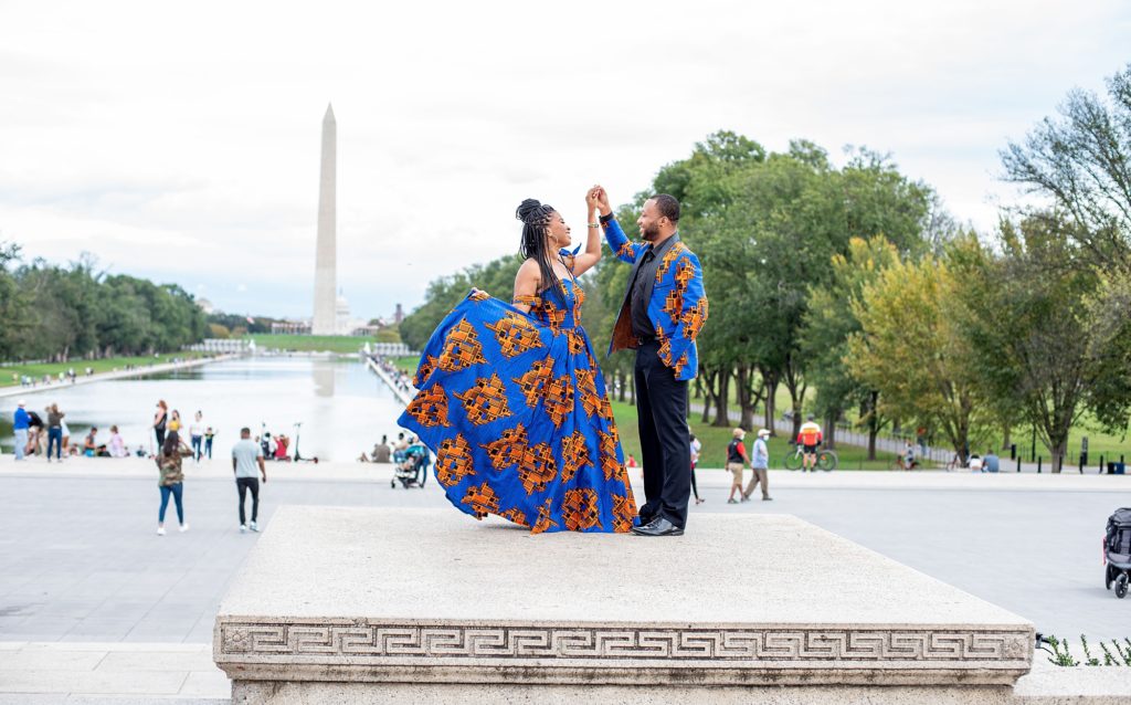 groom twirls fiancee during Lincoln Memorial engagement session