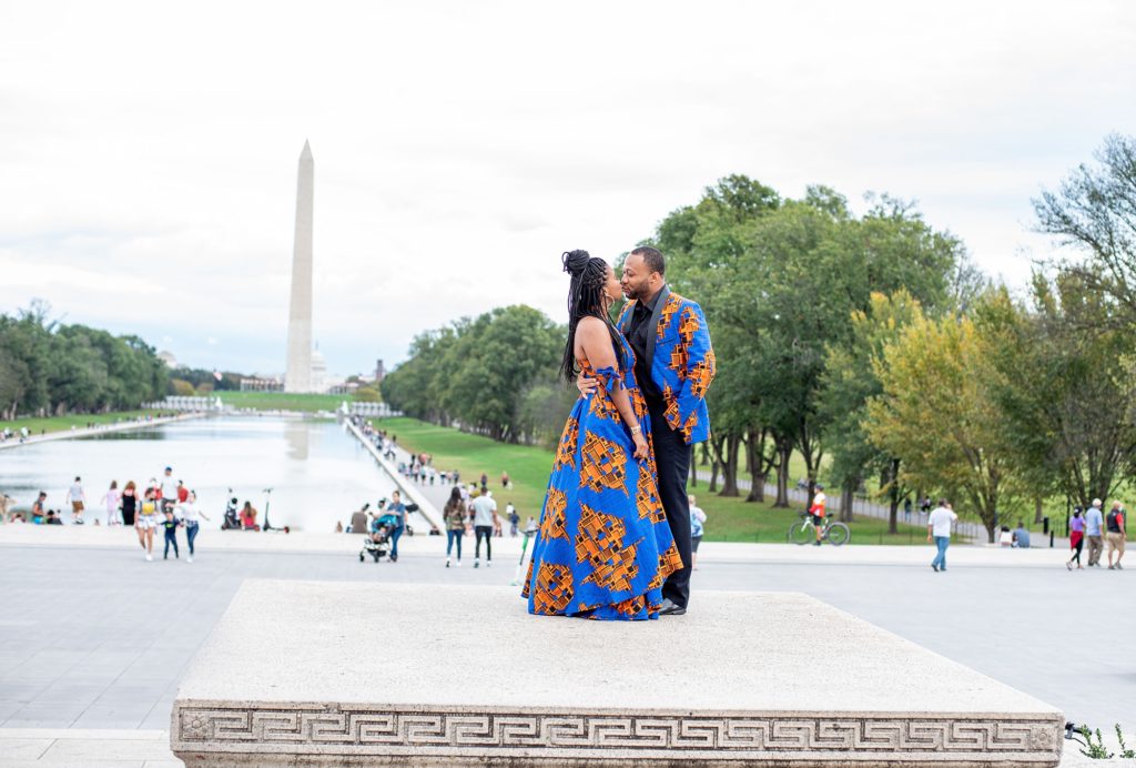 bride and groom kiss with Washington Monument in background