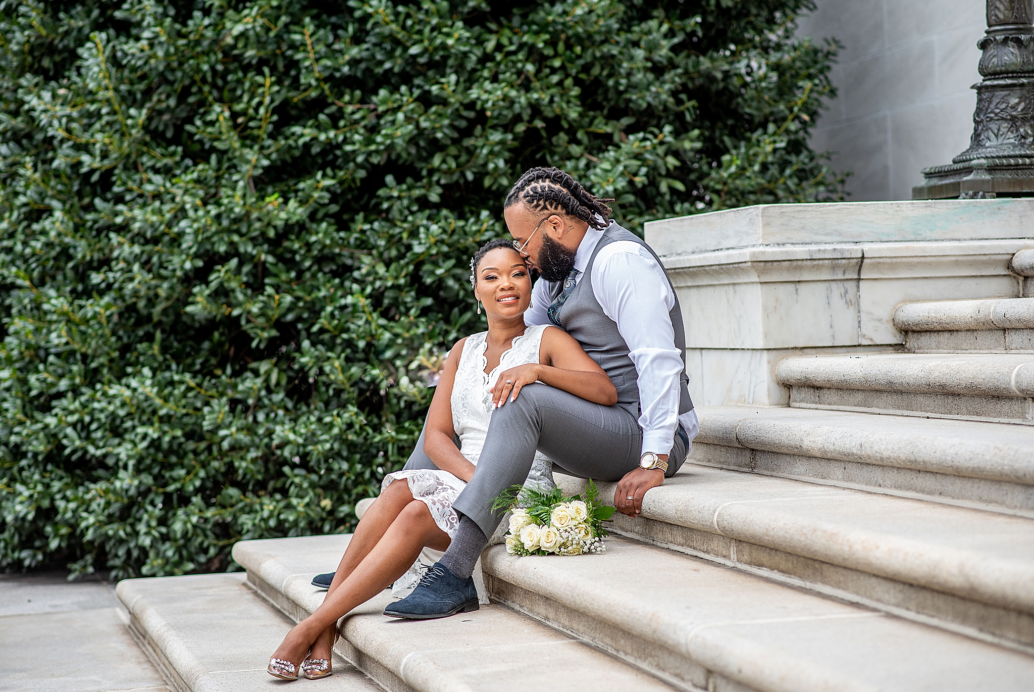 bride and groom sit on steps in Washington DC