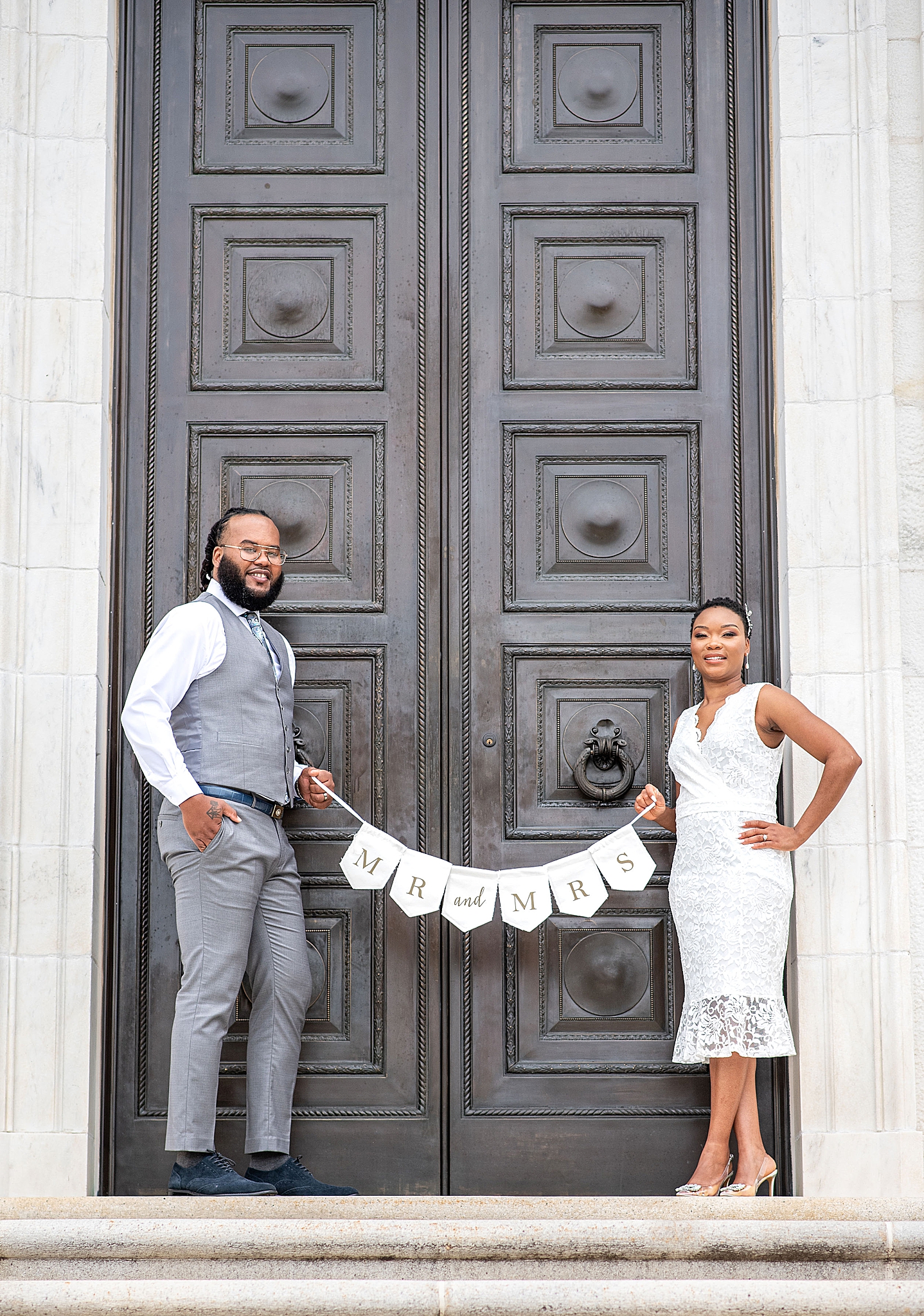 newlyweds hold mr & mrs sign in Washington DC