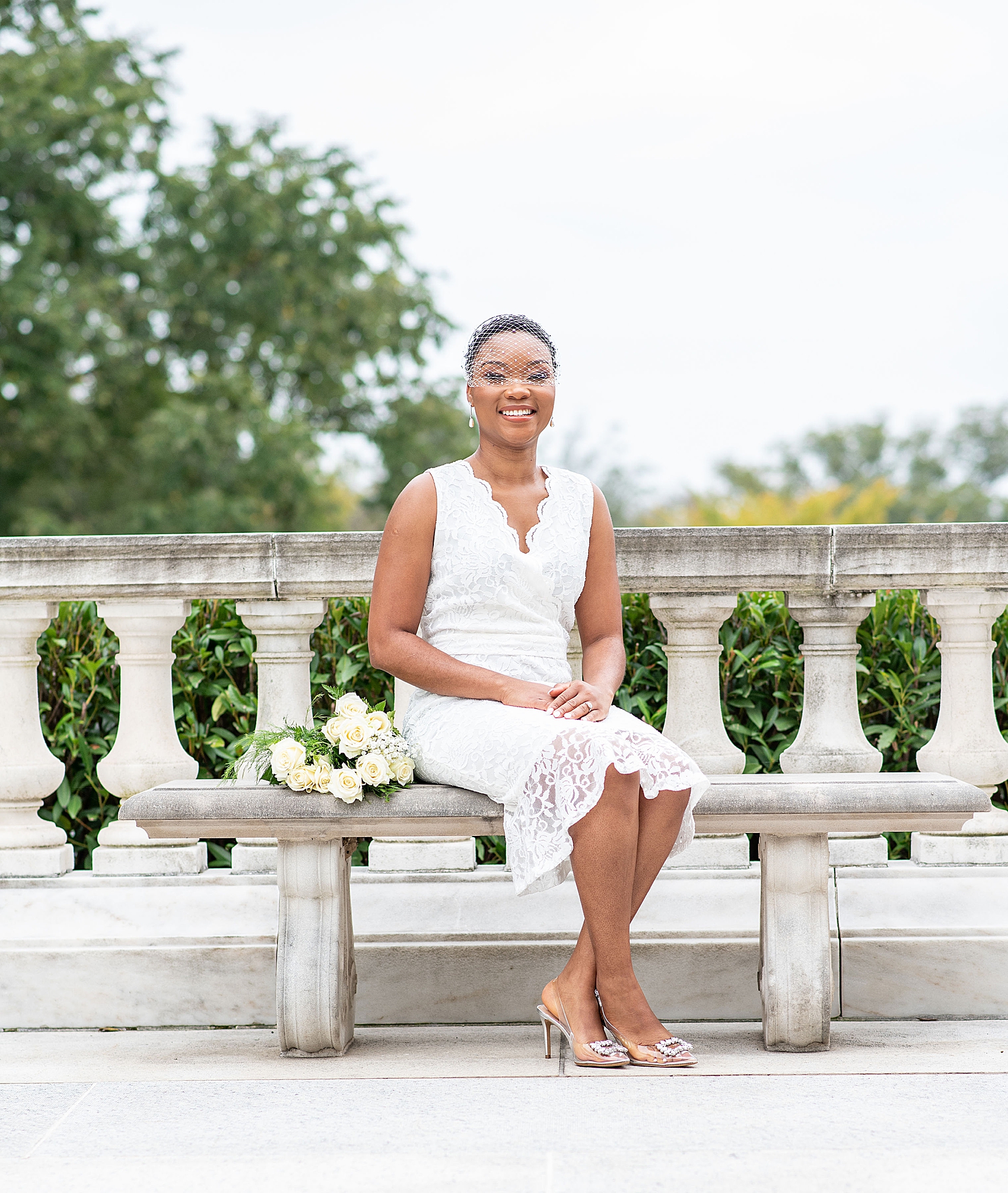bride sits on bench at American Institute of Pharmacy
