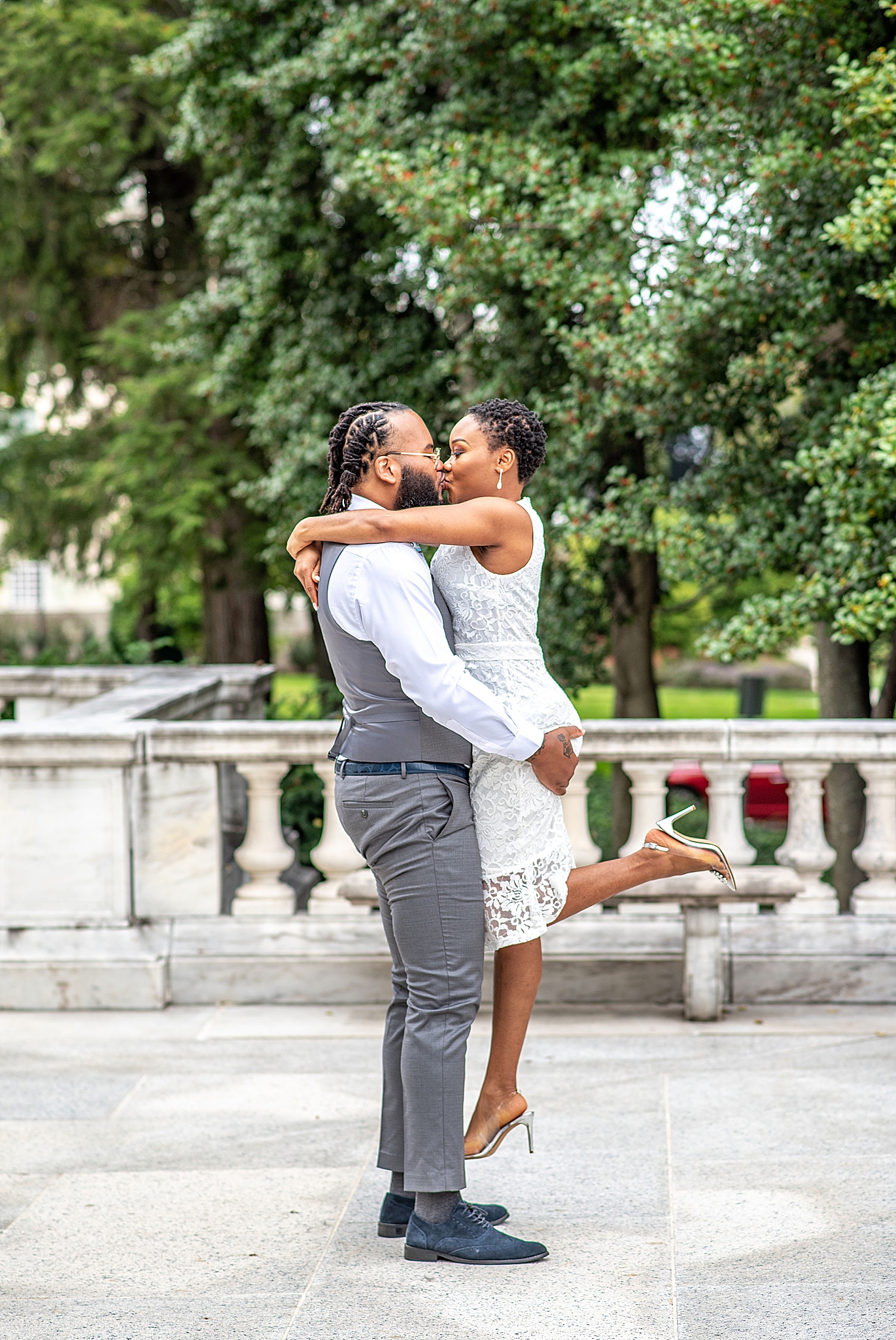 groom lifts bride up during DC wedding portraits 