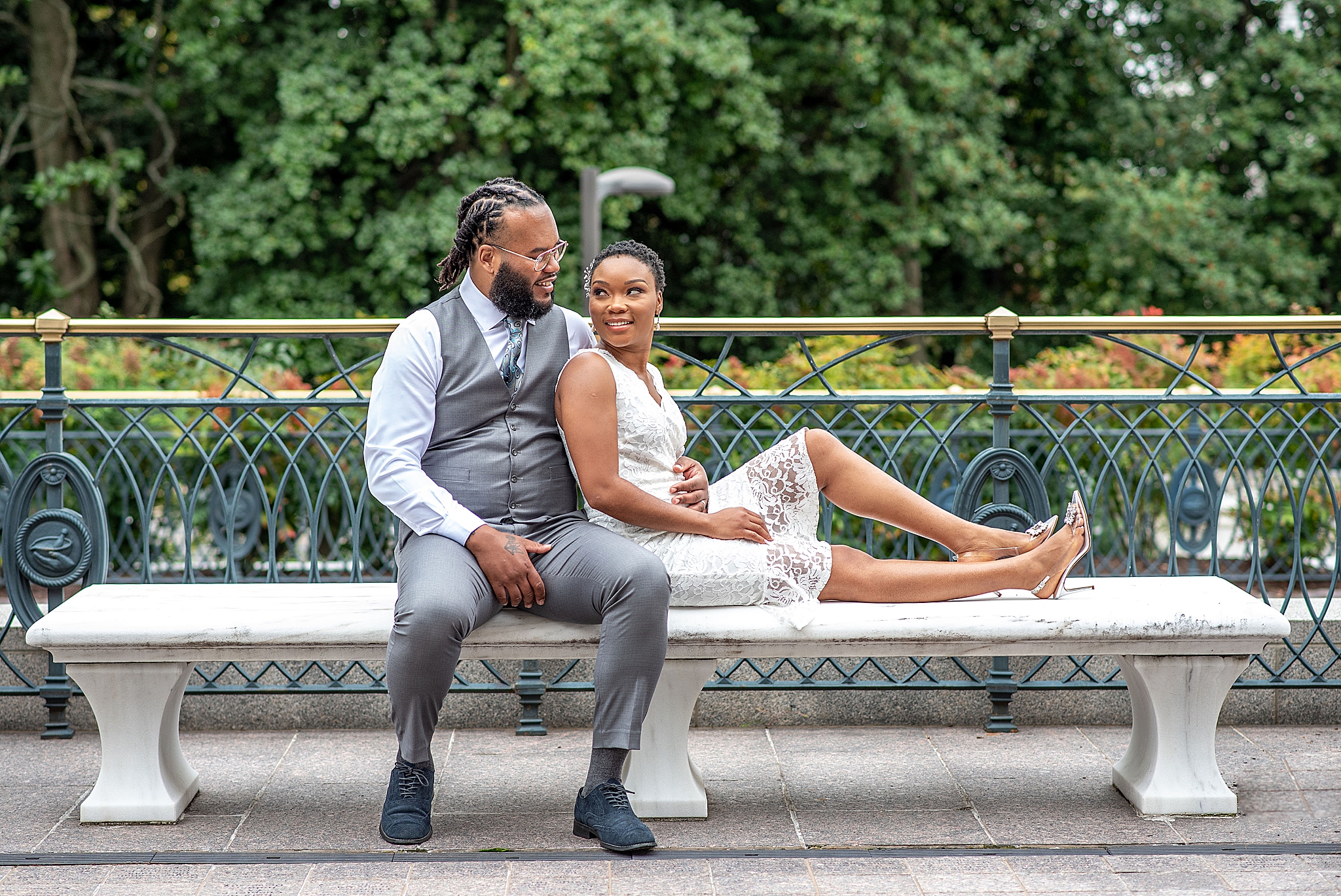 bride and groom sit on bench in Washington DC
