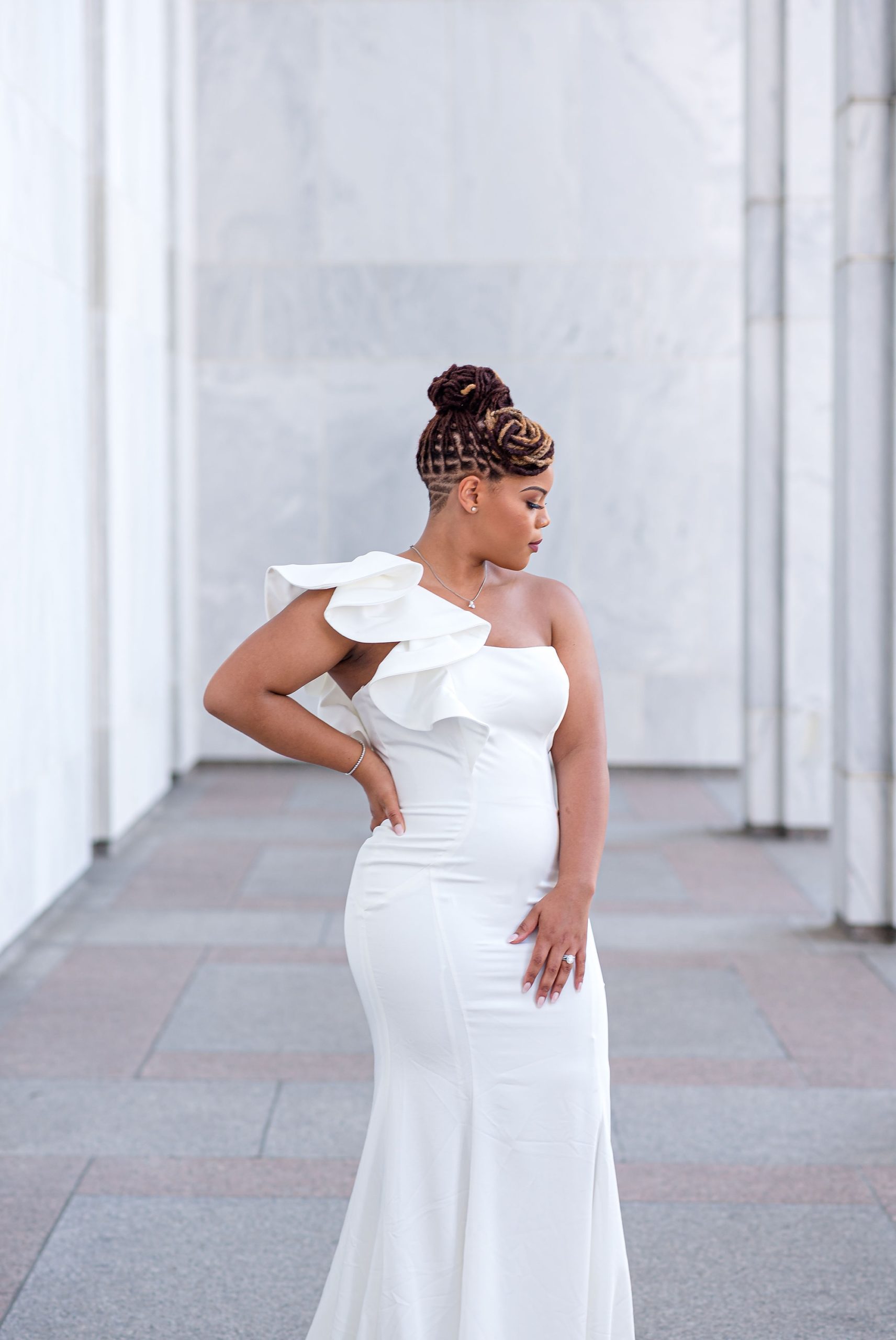 wife in white dress looks over shoulder during glamorous DC anniversary portraits