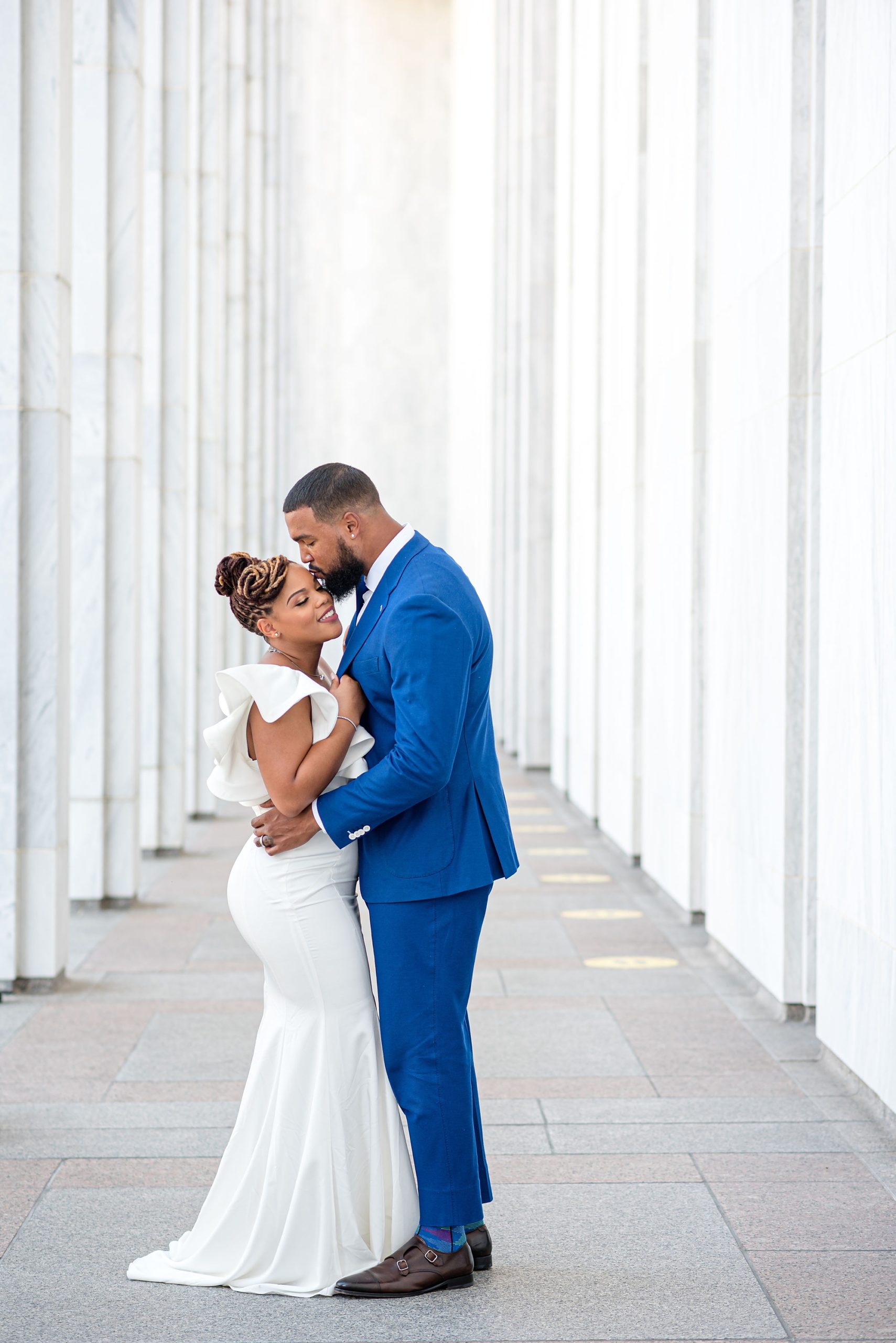 groom leans down kiss bride during portraits at the Library of Congress
