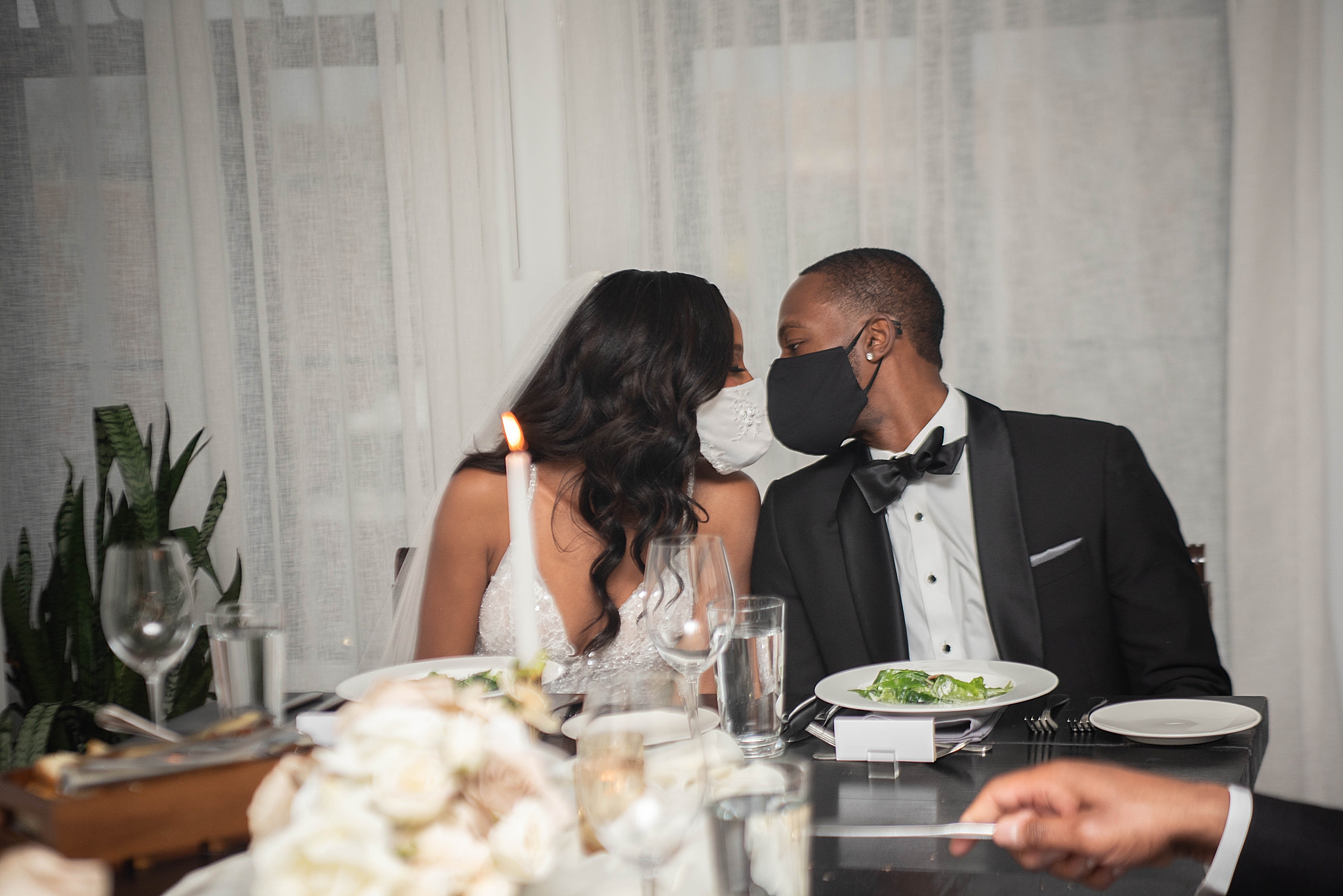 bride and groom kiss with masks during microwedding