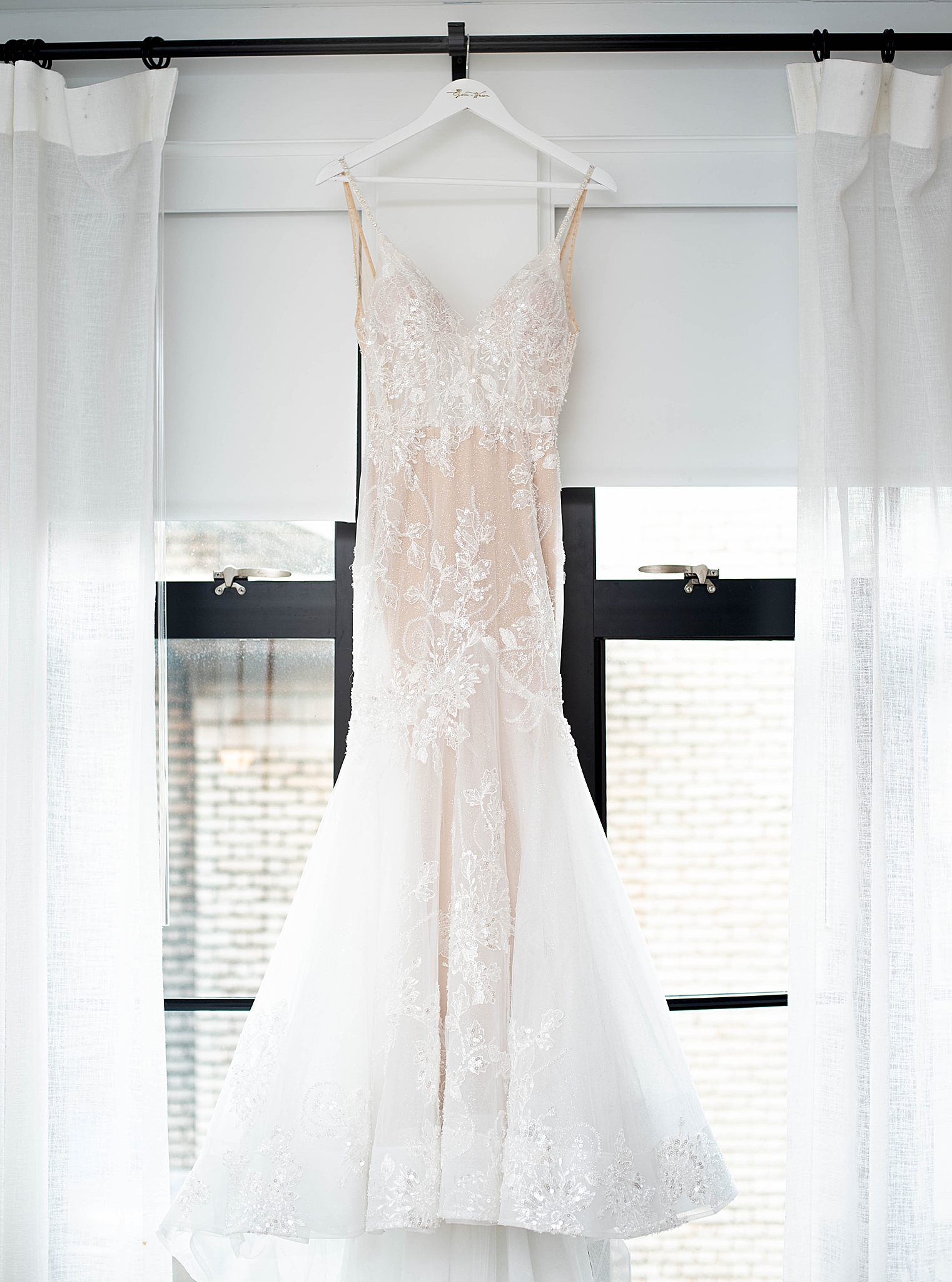 bride's dress hangs in Washington DC window