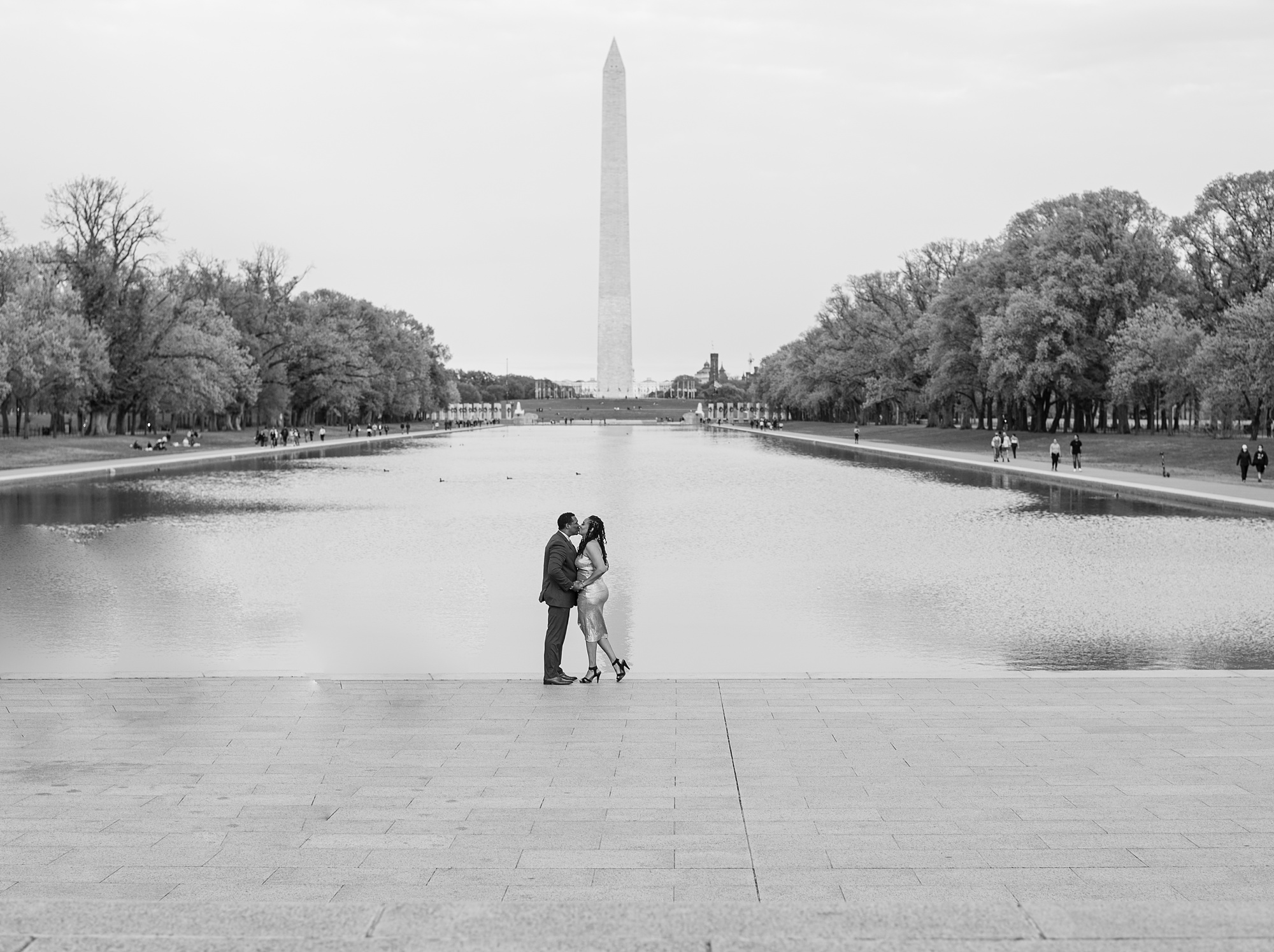 engaged couple stands by Reflection Pool in DC