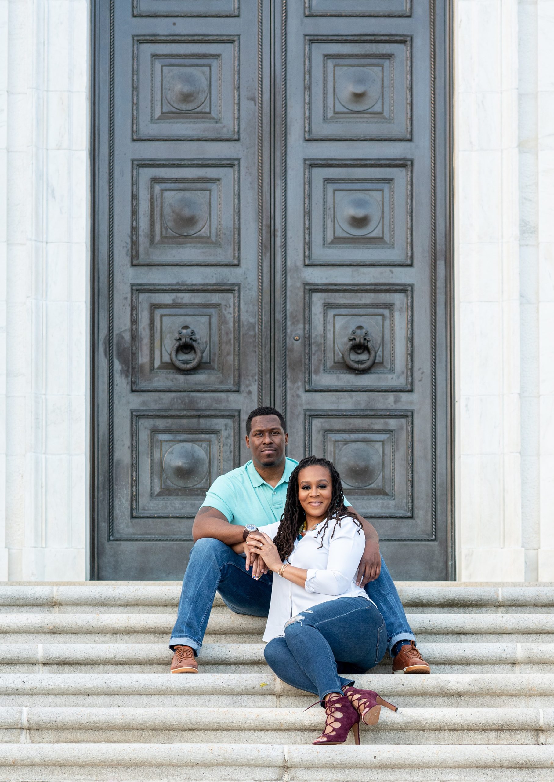 engaged couple sits on steps in Washington DC