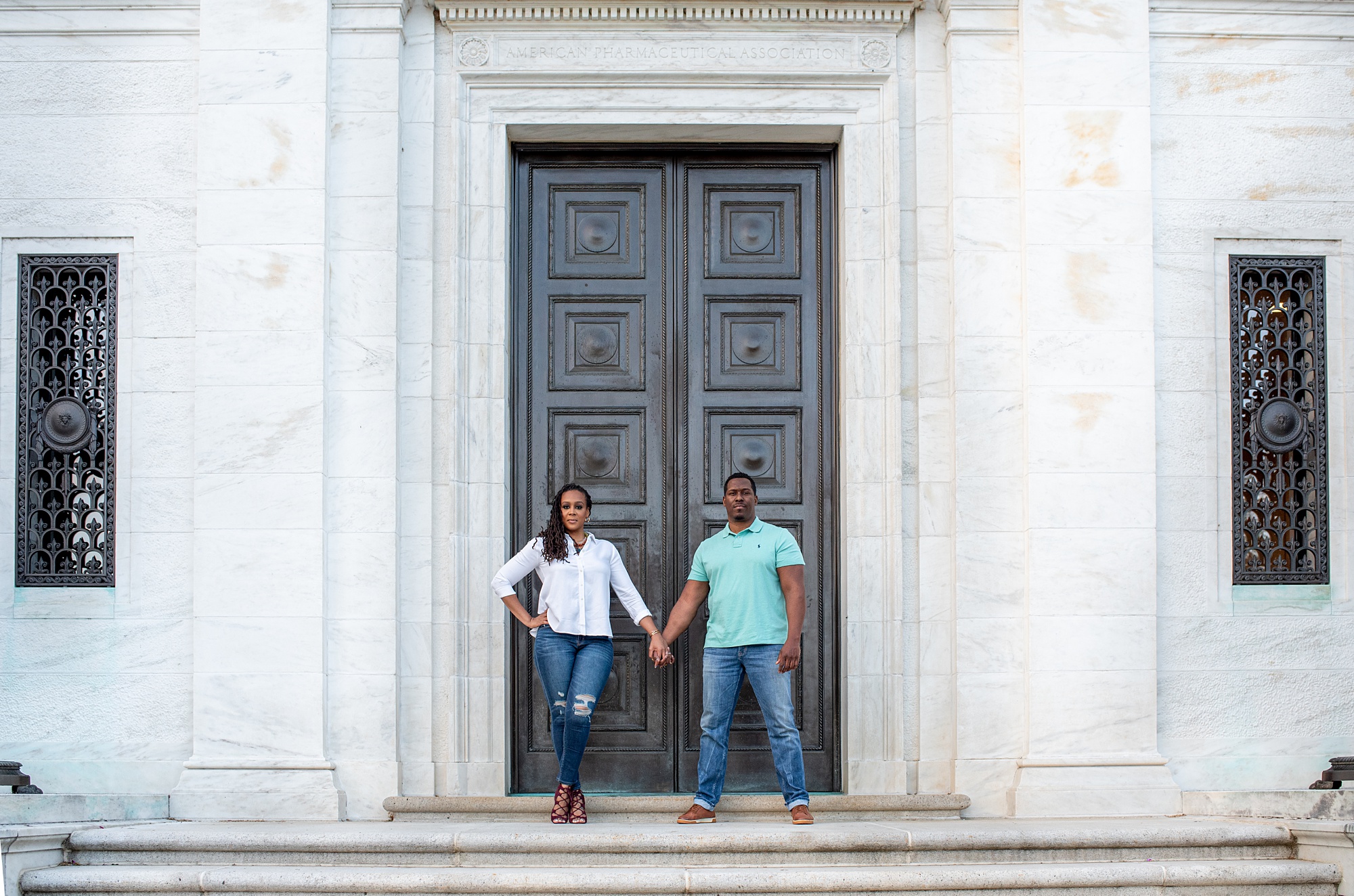 bride and groom hold hands by doorway in Washington DC