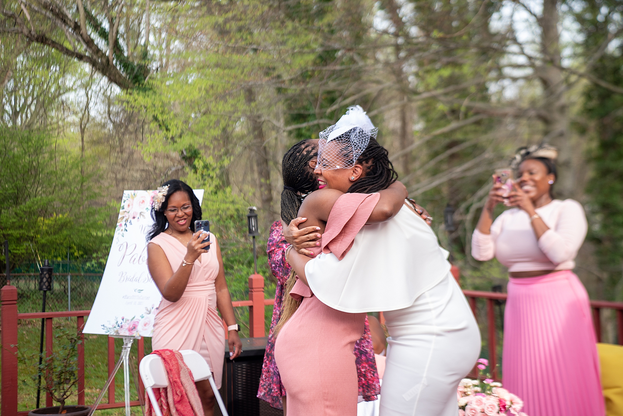 bride hugs guests during Maryland bridal shower