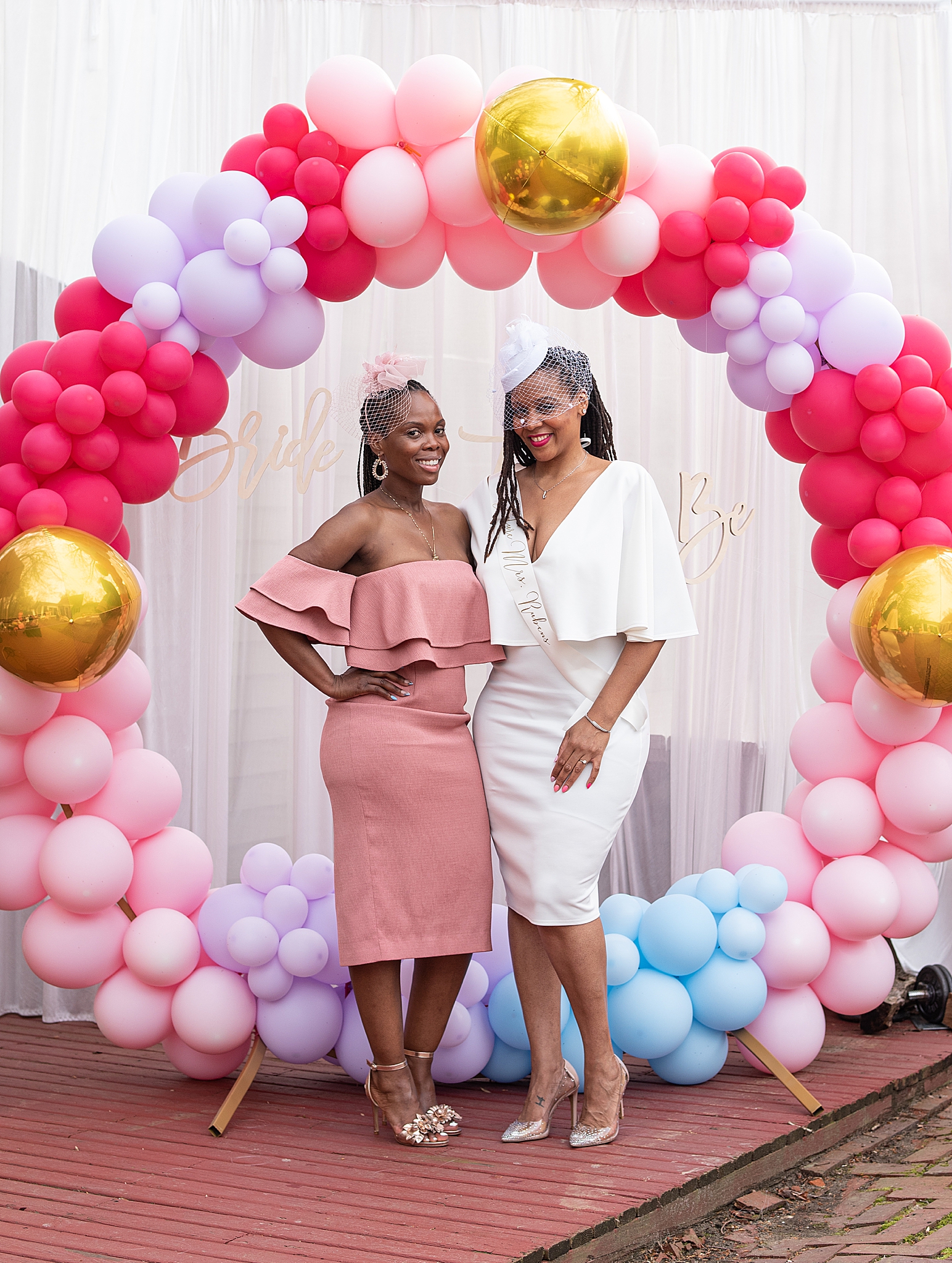 bride poses with guest during bridal shower