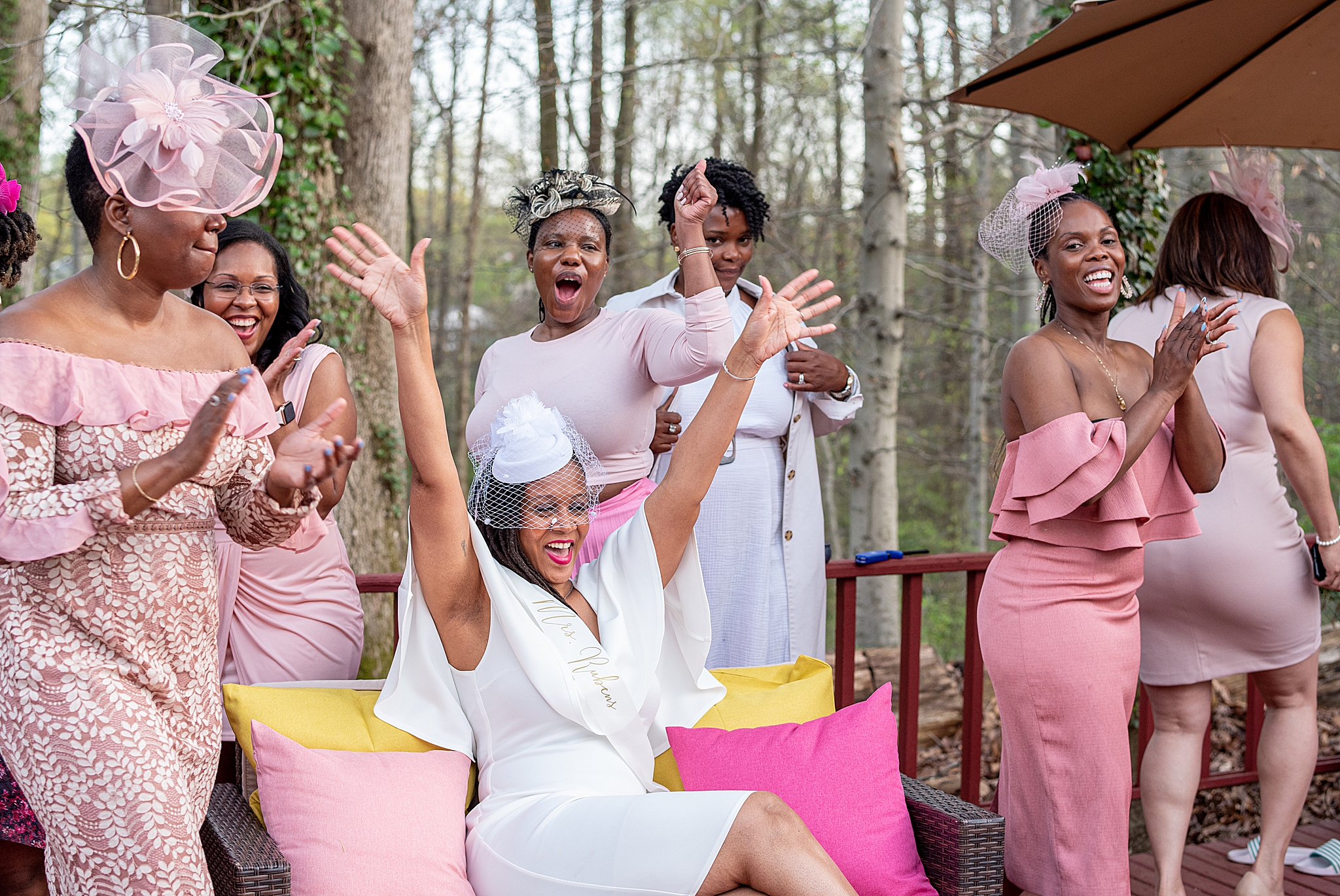 bride cheers posing with guests during Maryland bridal shower
