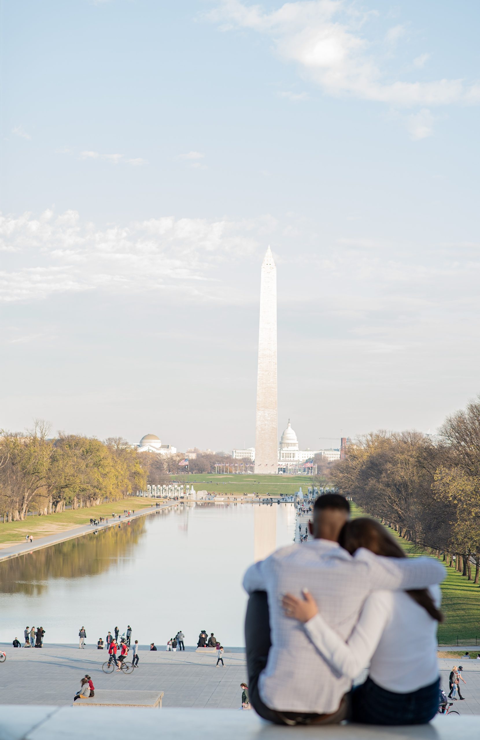 engaged couple sits on the steps of Lincoln Memorial after proposal in DC