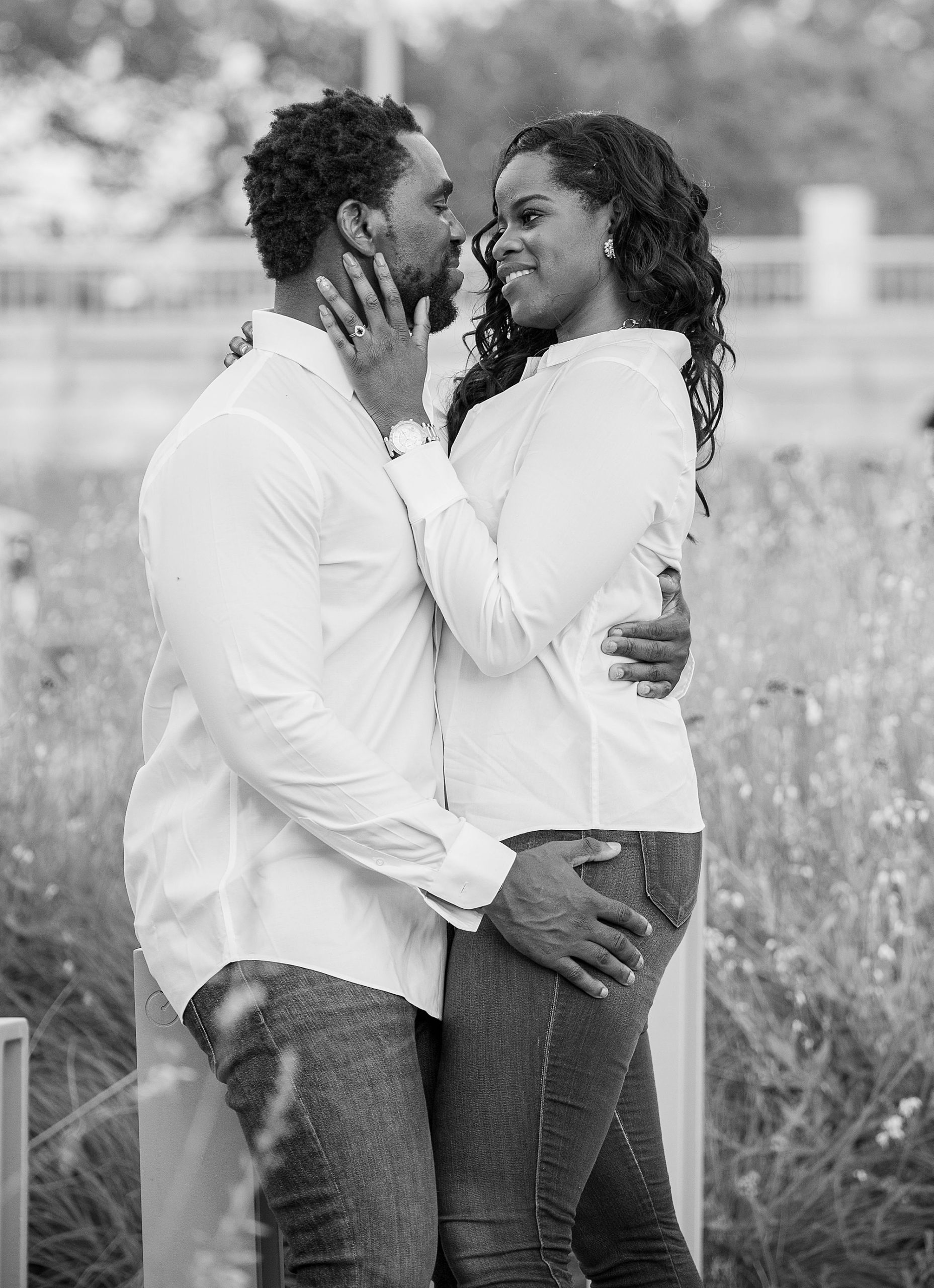 bride holds groom's face during Kennedy Center engagement session
