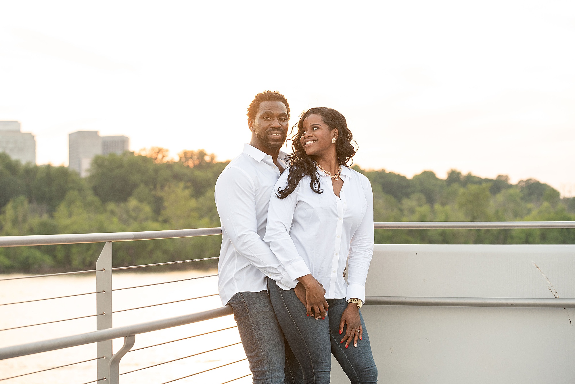 engaged couple poses on rooftop of Kennedy Center