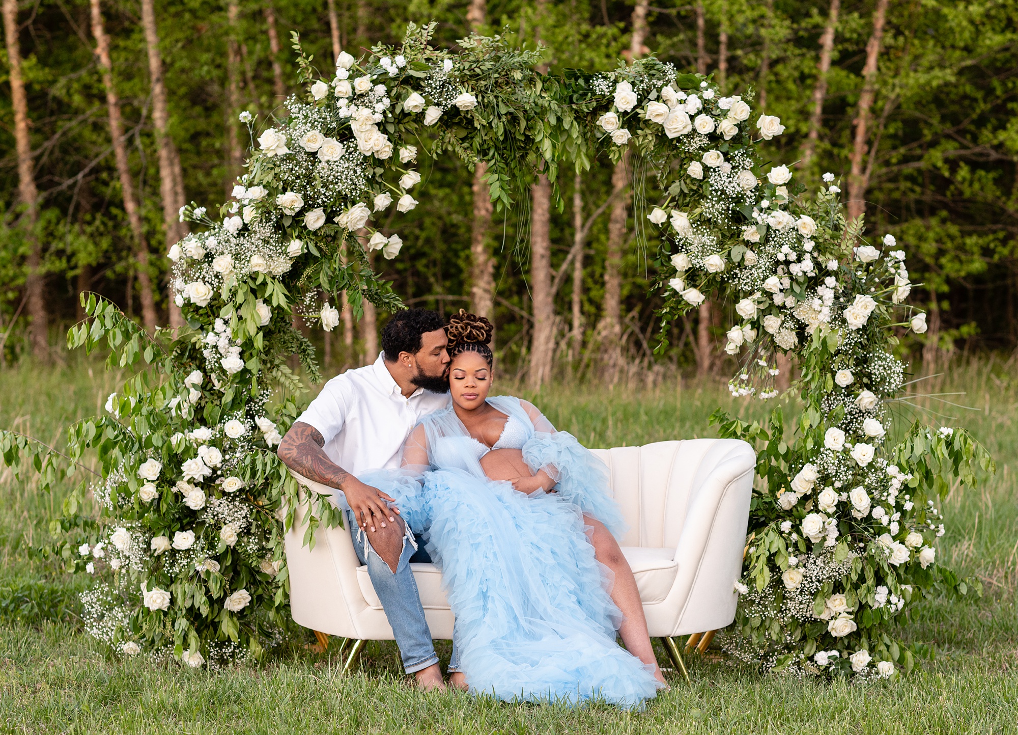 spring maternity portraits under floral arbor with Washington DC maternity photographer