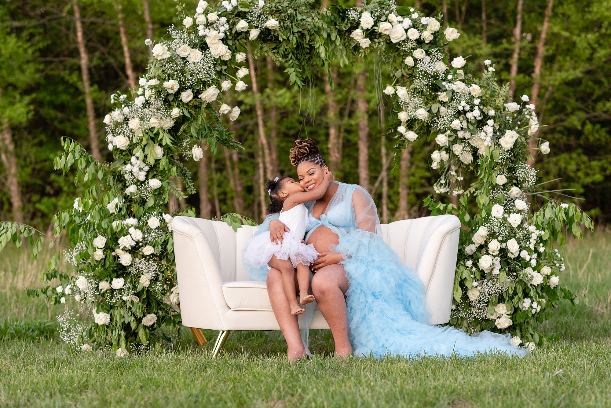 toddler kisses mom's cheek during spring maternity photos with Washington DC maternity photographer