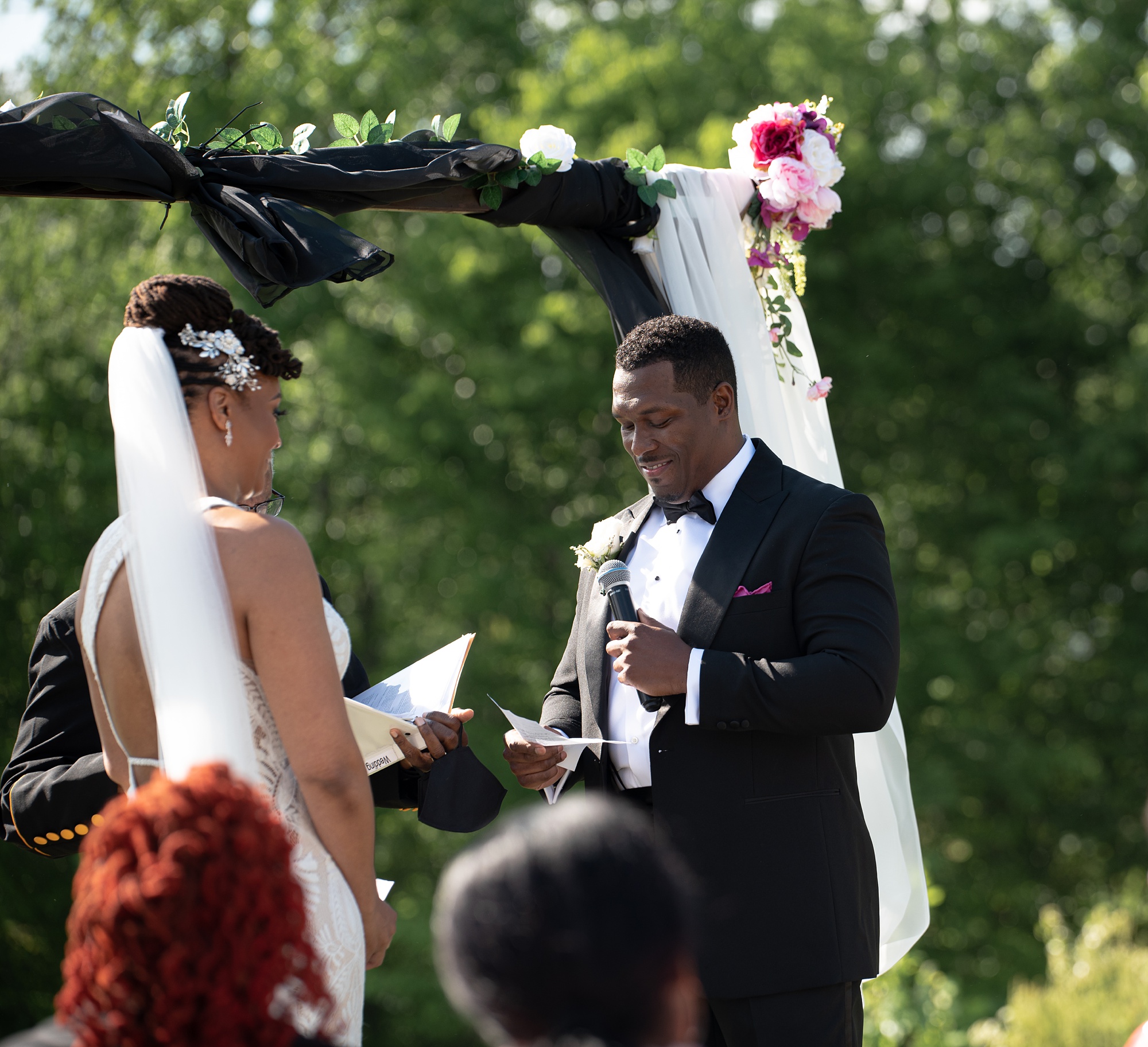 bride reads vows to groom during wedding ceremony