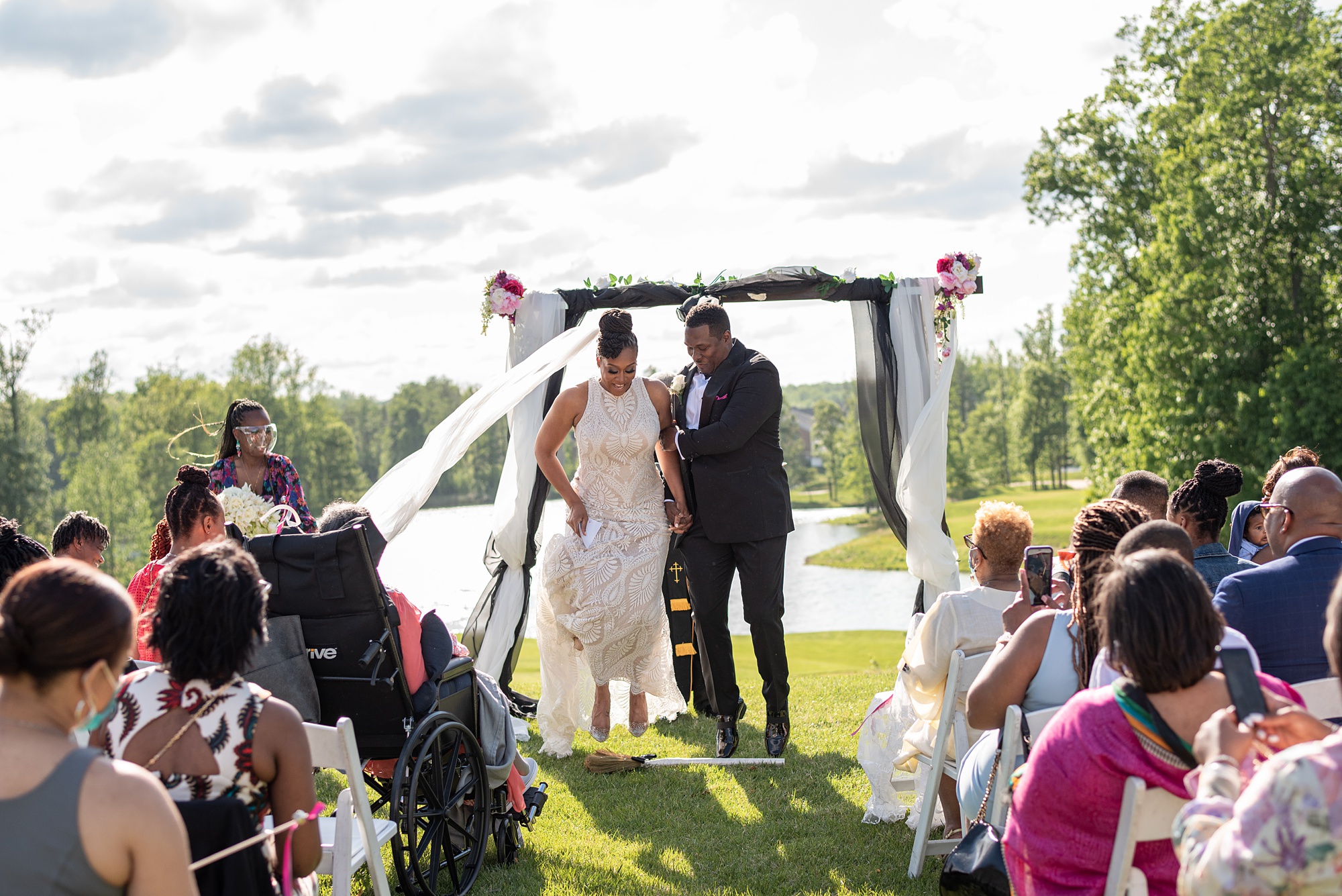bride and groom jump broom during ceremony in Maryland 