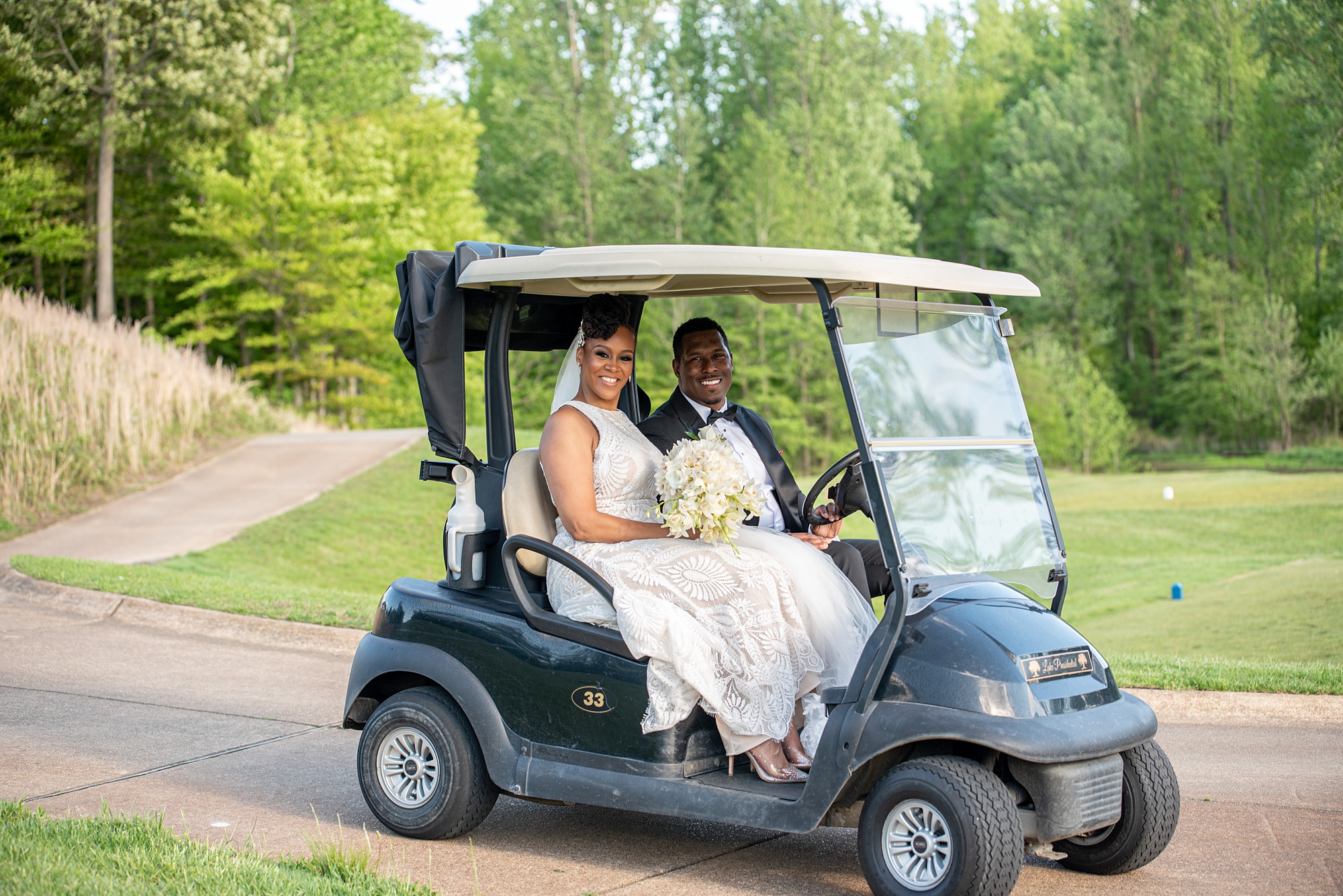 bride and groom ride on golf cart through Marlboro MD golf course 