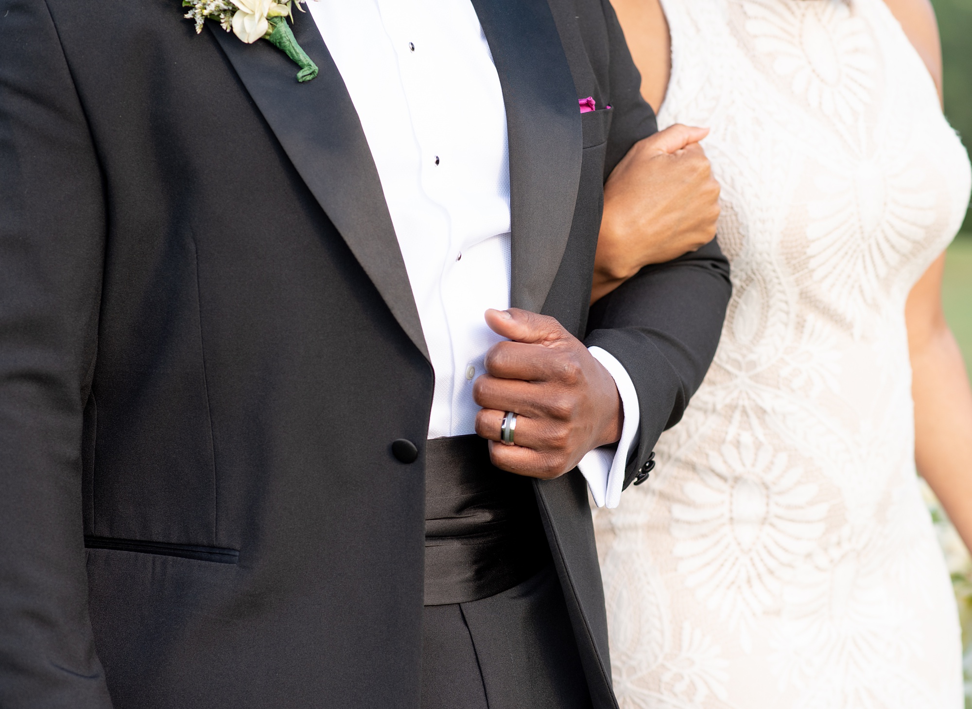 bride holds groom's arm during Upper Marlboro Lake Presidential Golf Course wedding photos