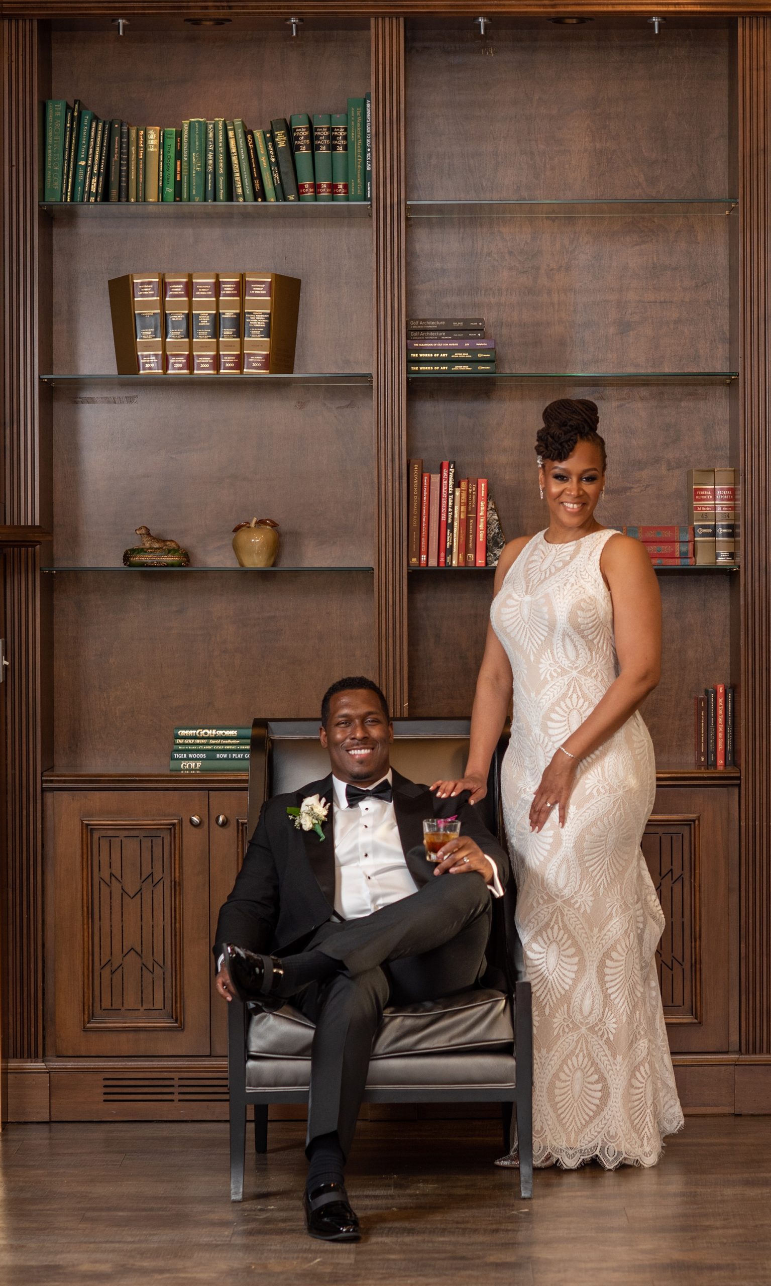bride and groom pose in library at Upper Marlboro Lake Presidential Golf Course