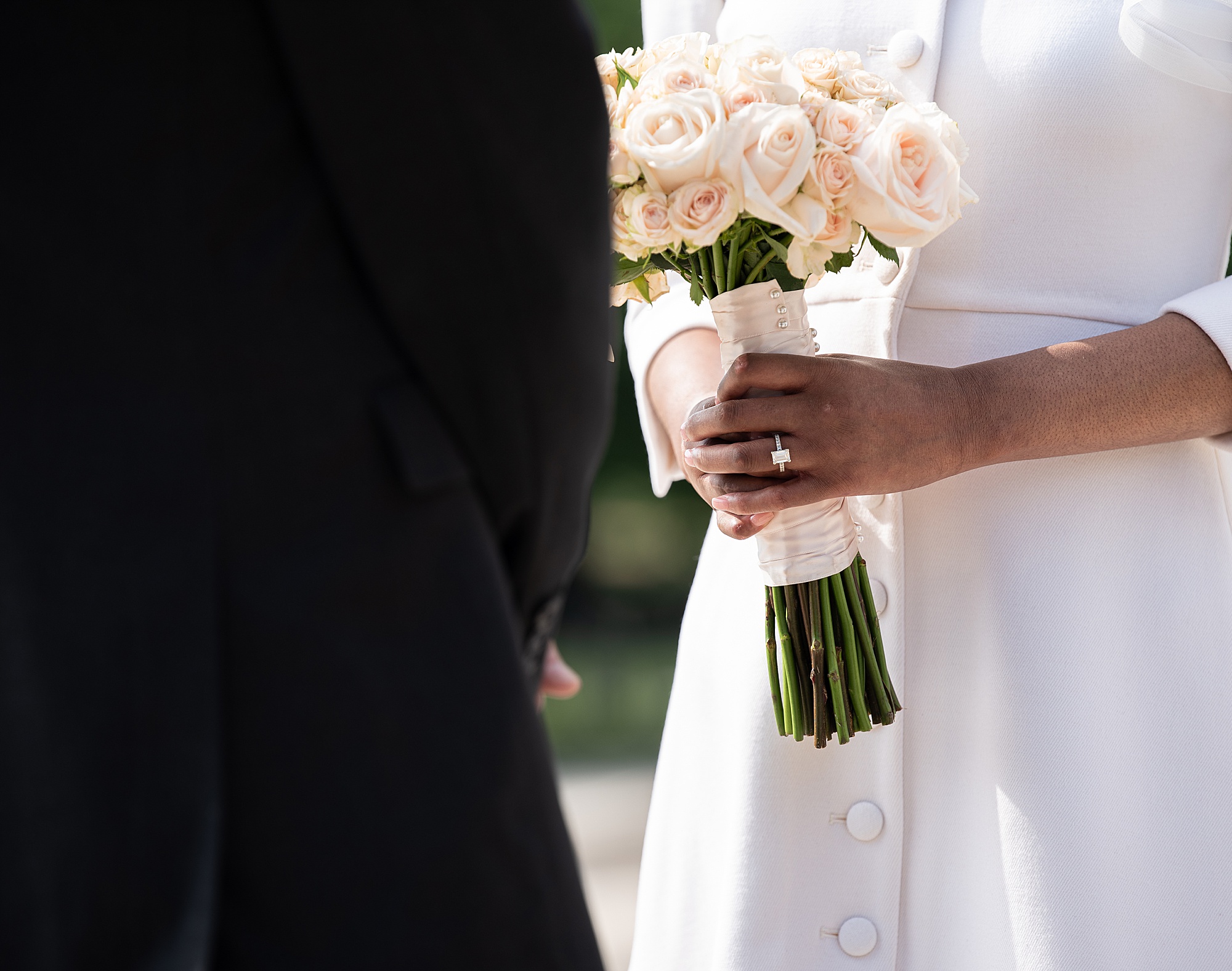 bride holds bouquet of roses for Lincoln Memorial wedding ceremony