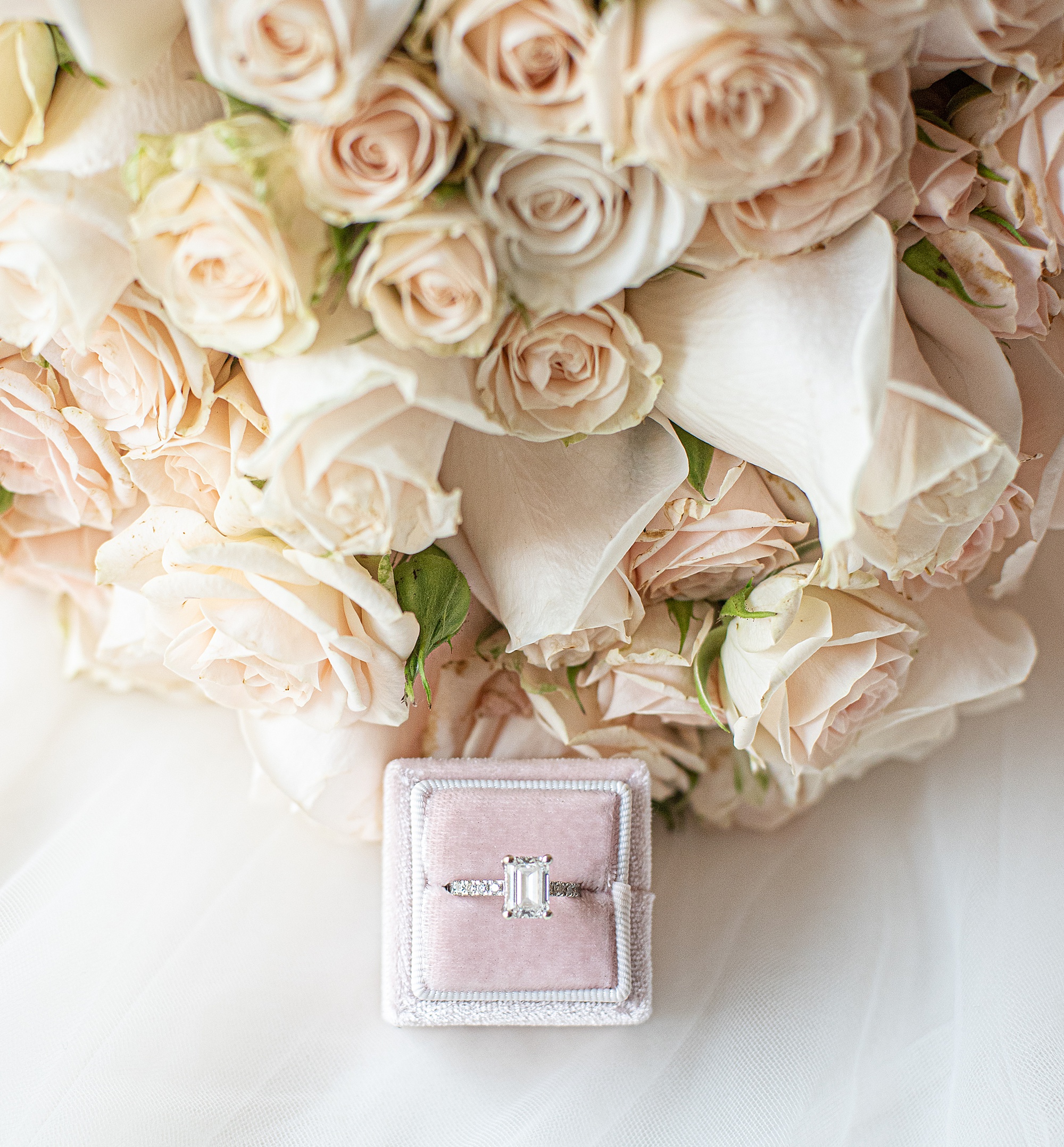 bride's ring rests in pink box
