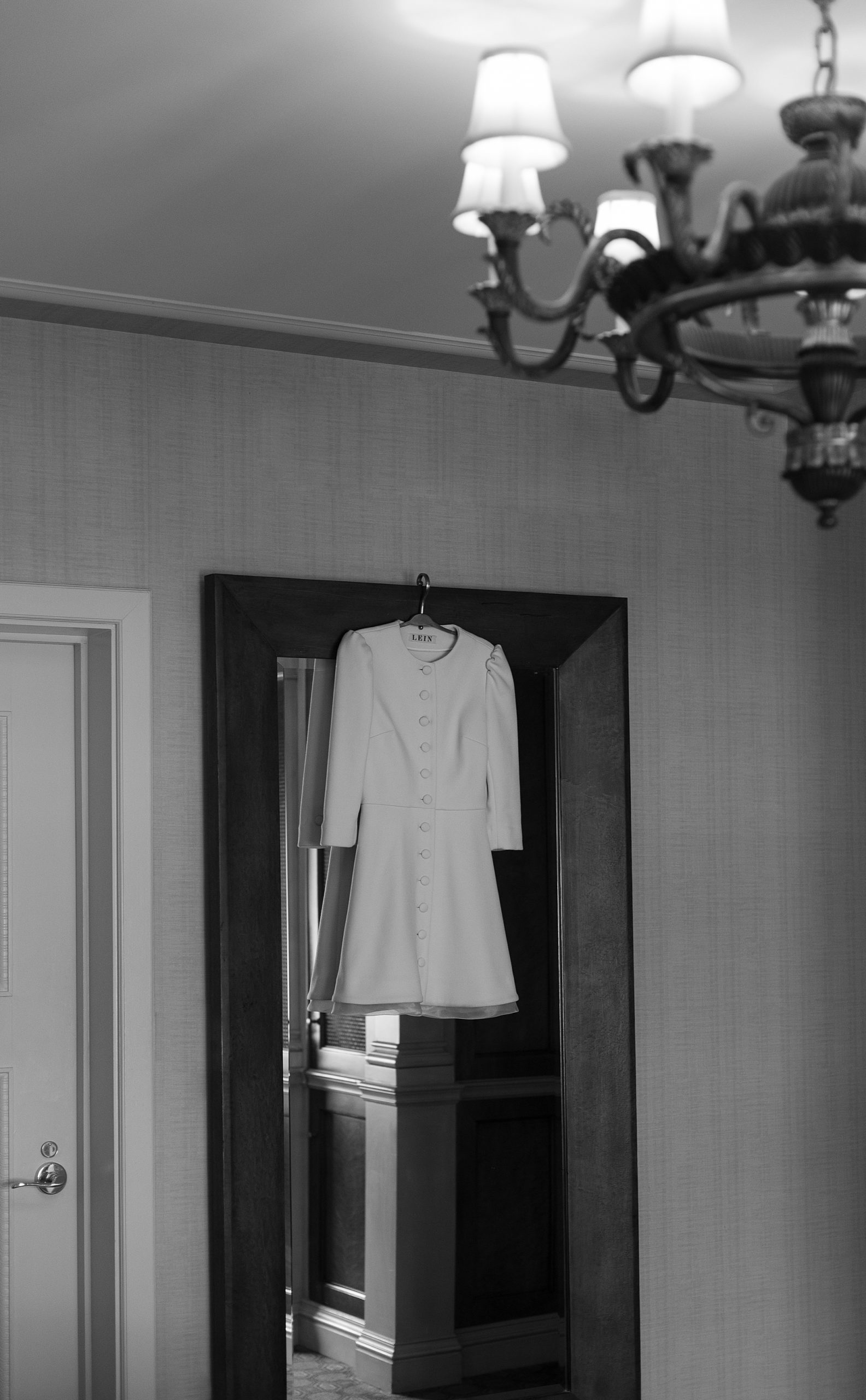 bride's dress hangs in doorway at St. Regis Hotel