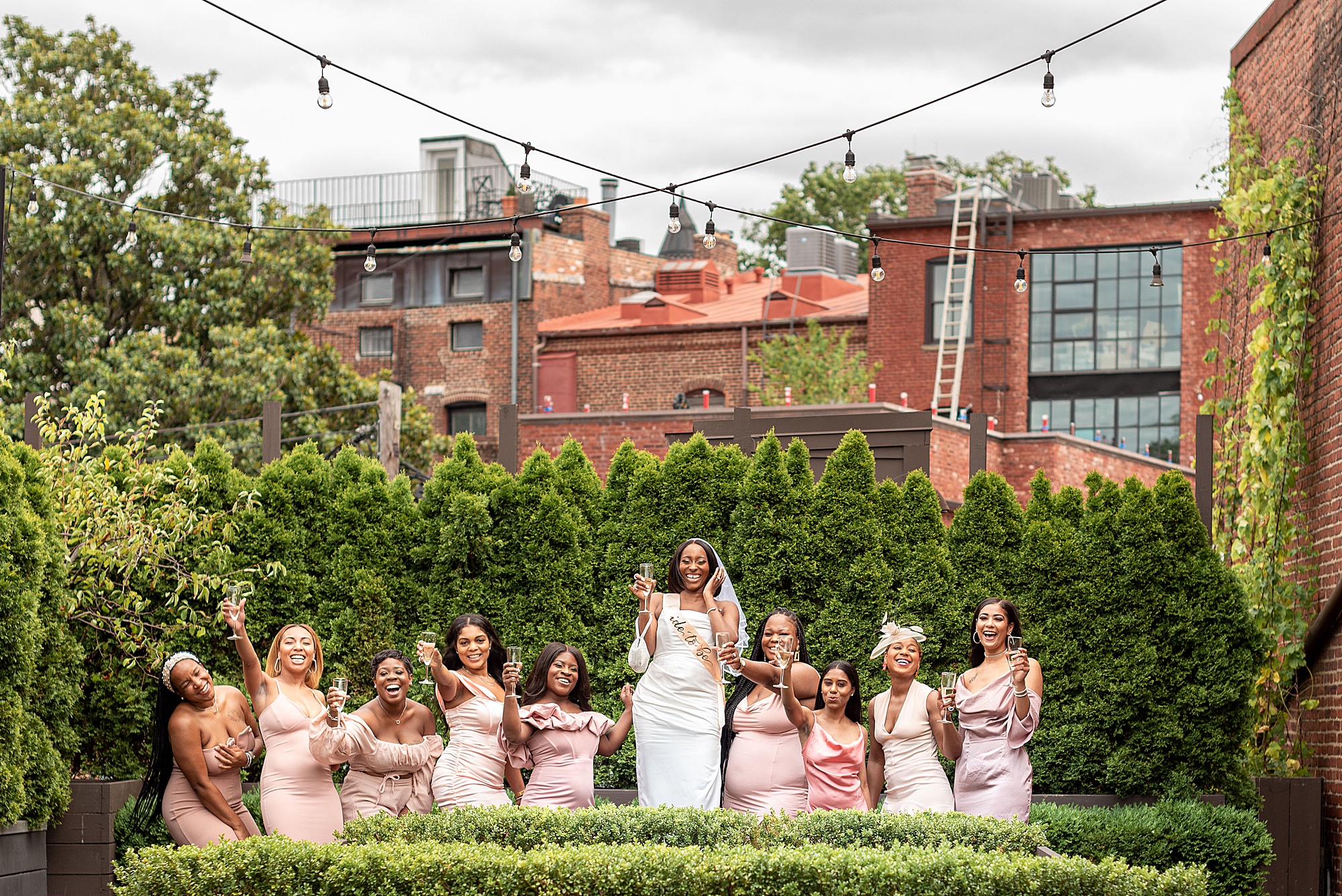 bride toasts at table with bridesmaids in Washington DC