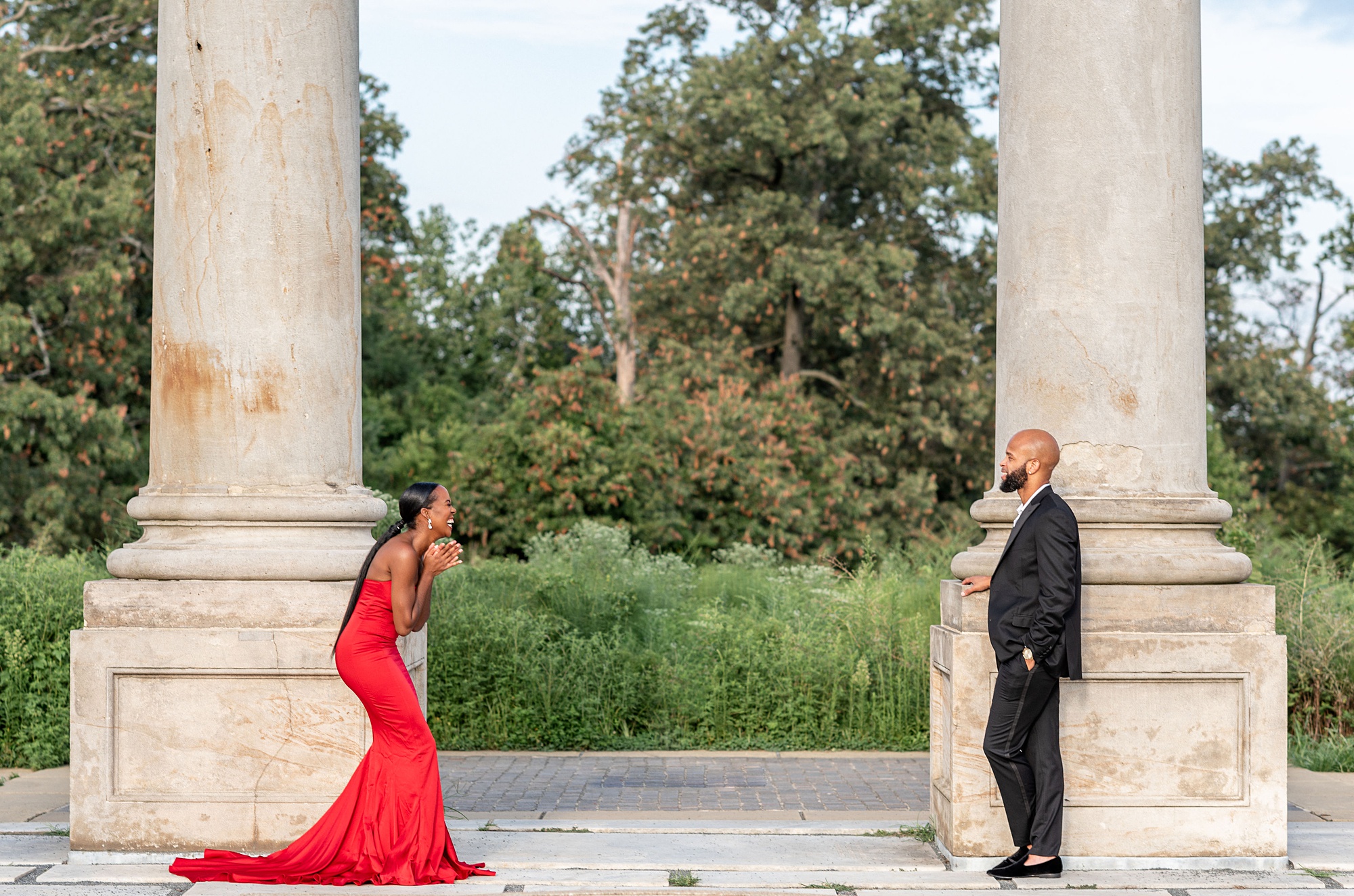 bride and groom laugh standing by columns in Washington DC