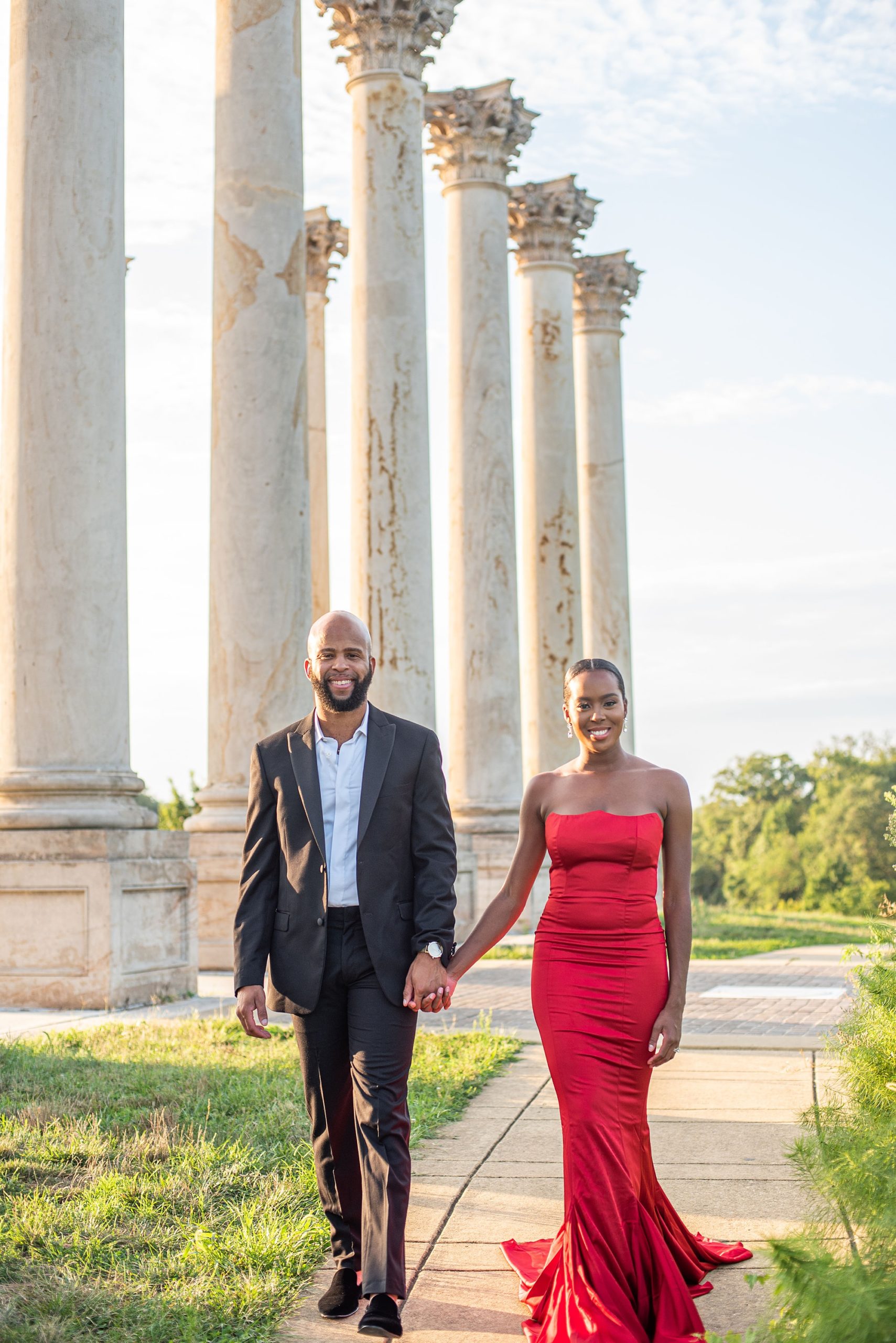 couple holds hands walking through National Arboretum