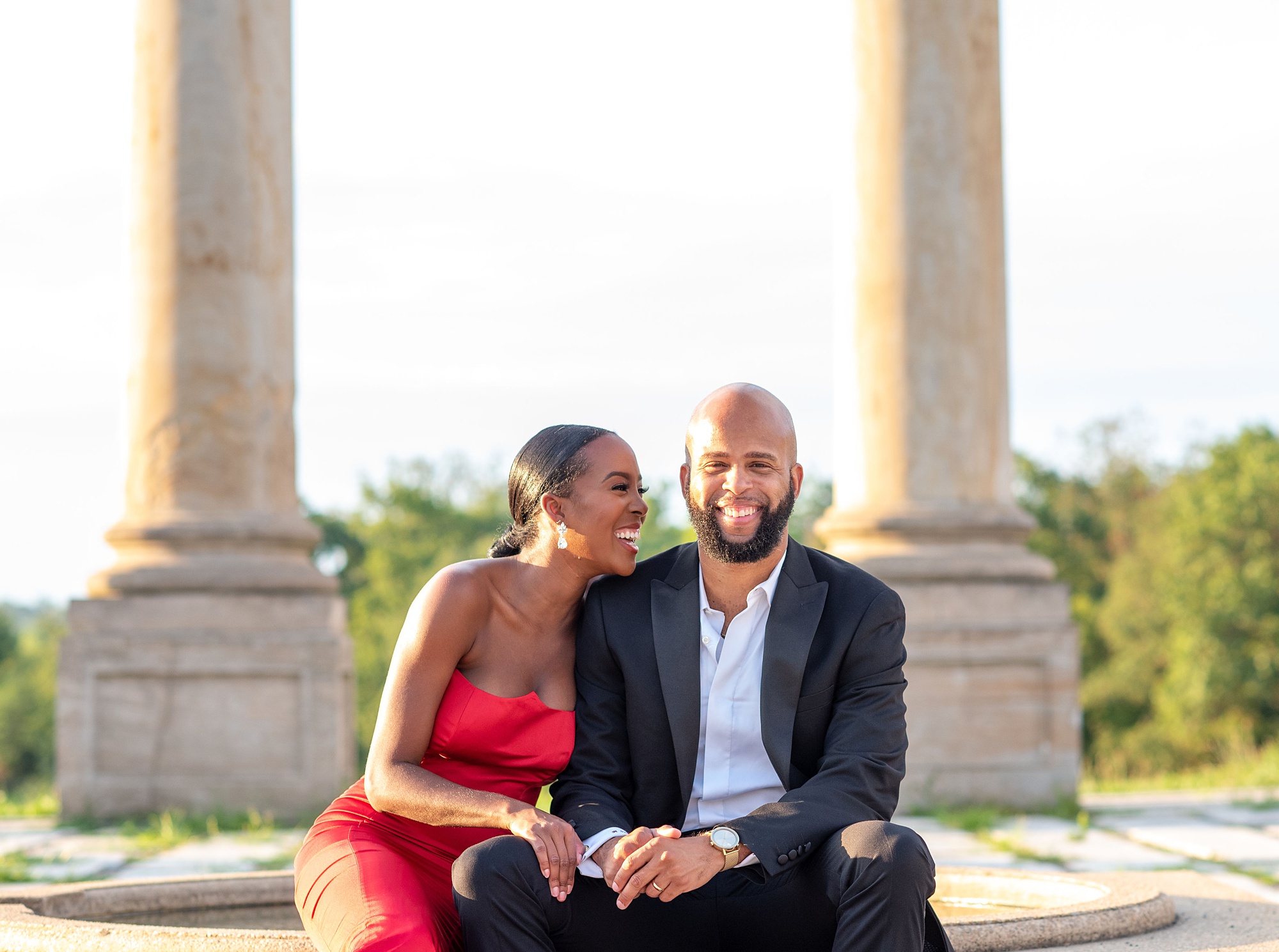 bride and groom laugh together during engagement session