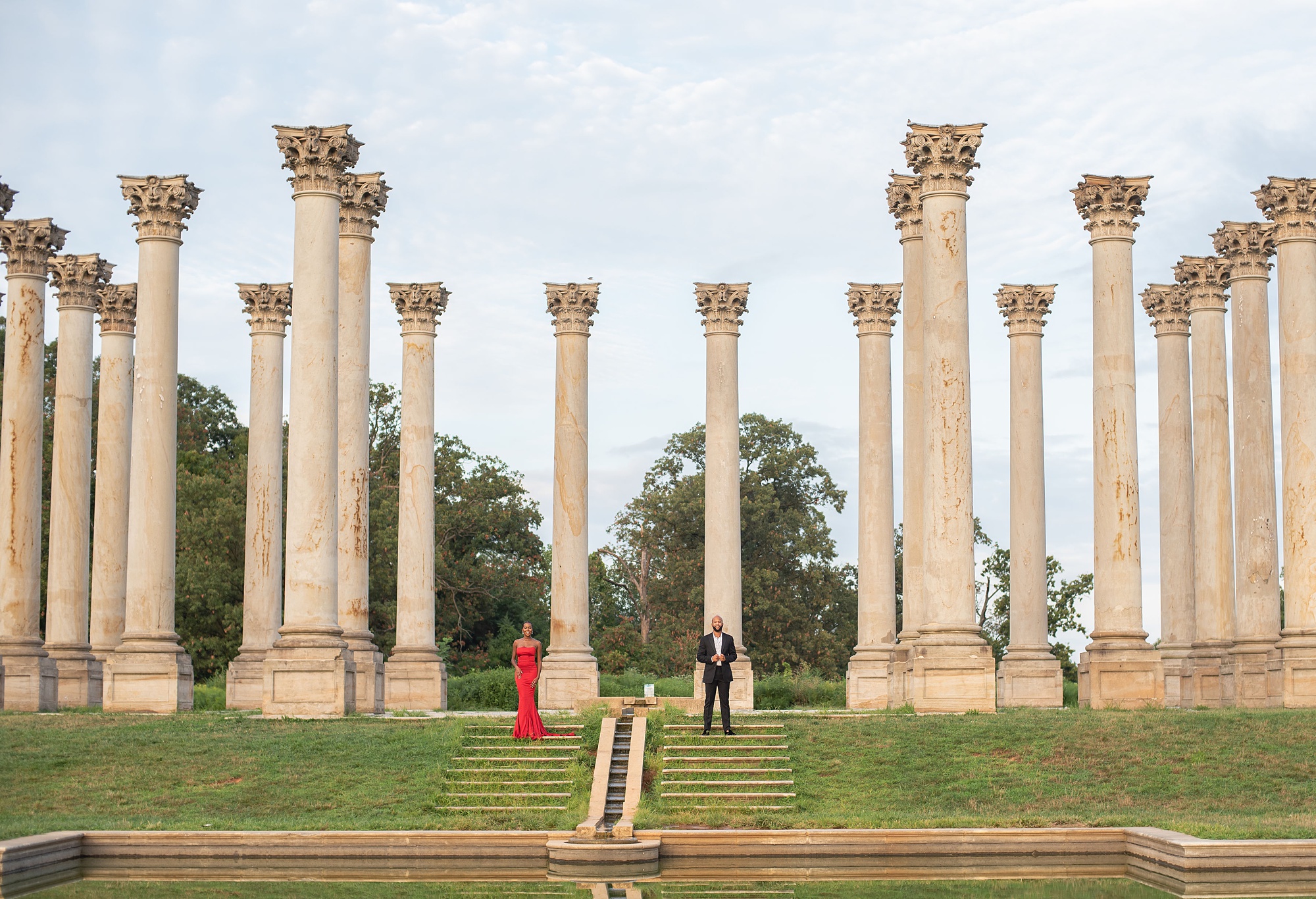engaged couple stands on steps of National Arboretum 