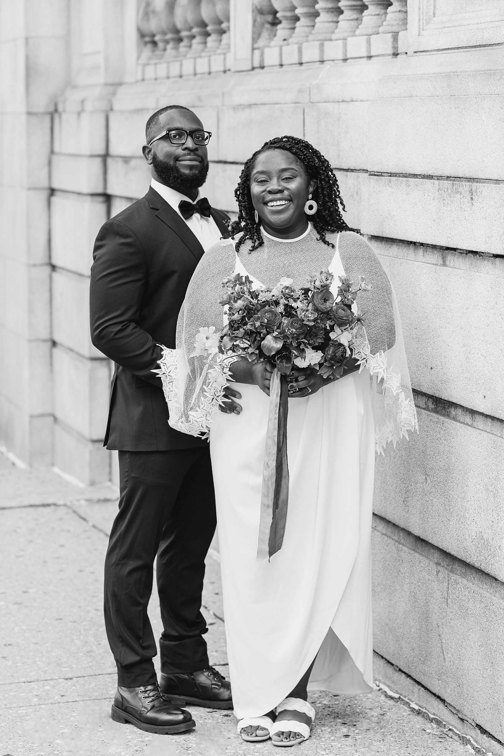 newlyweds pose by courthouse in Baltimore MD