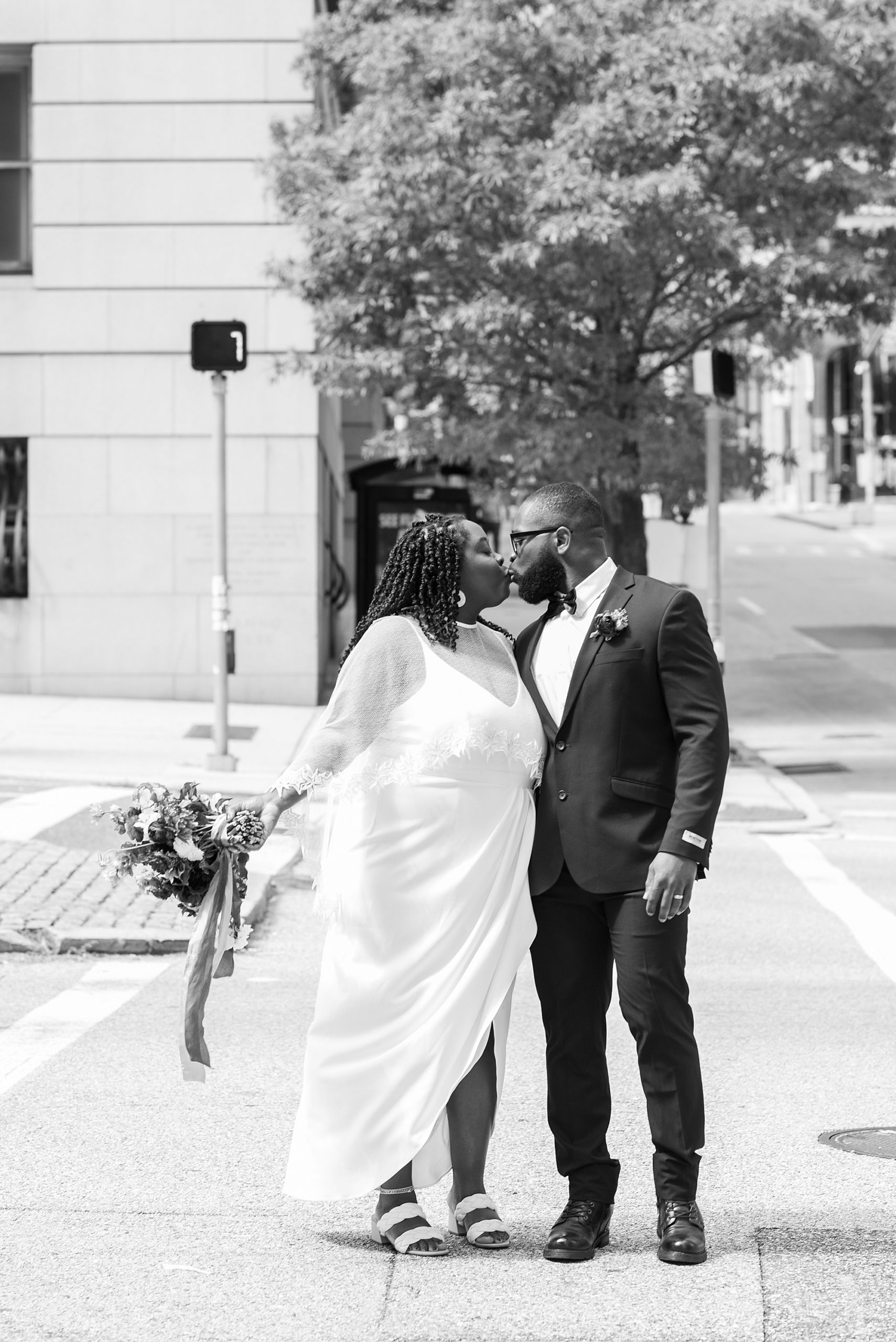 newlyweds kiss on street in Baltimore MD