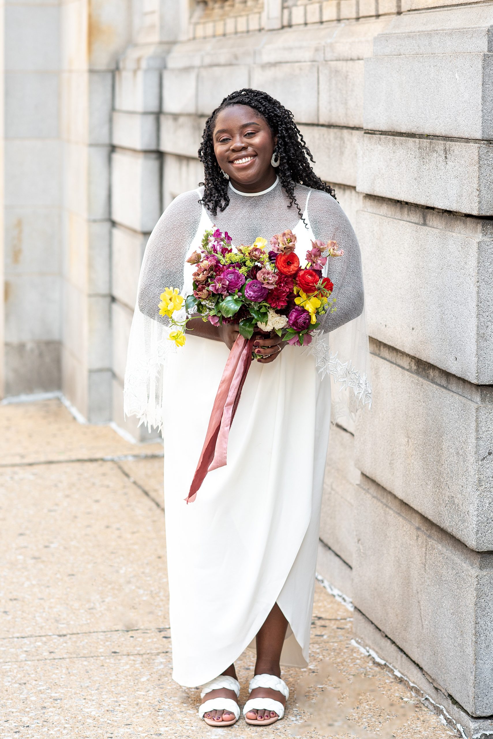bride poses with colorful bouquet in Baltimore MD