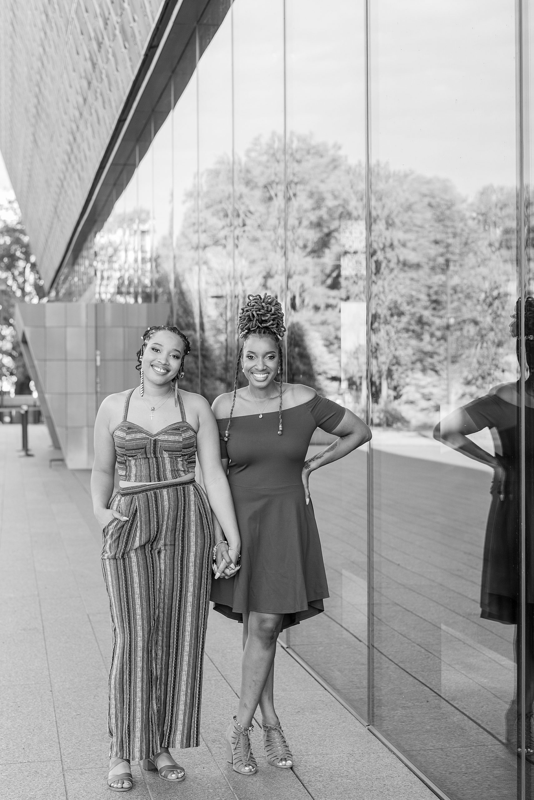 women walk outside the National Museum of African American History and Culture