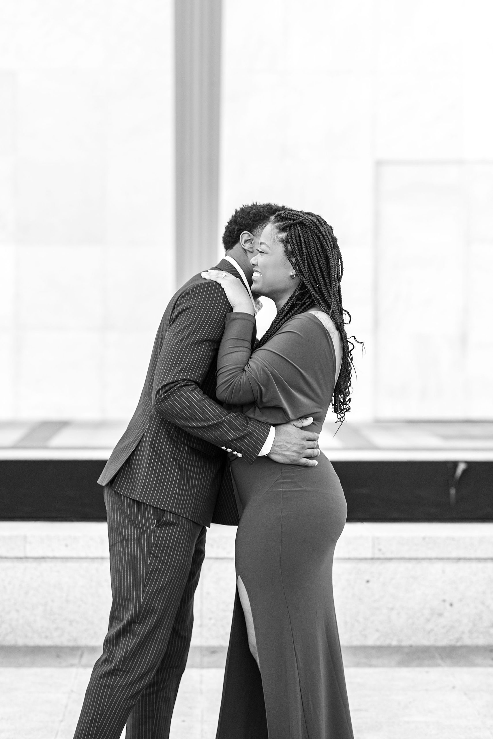 engaged couple laughs together during Kennedy Center engagement portraits