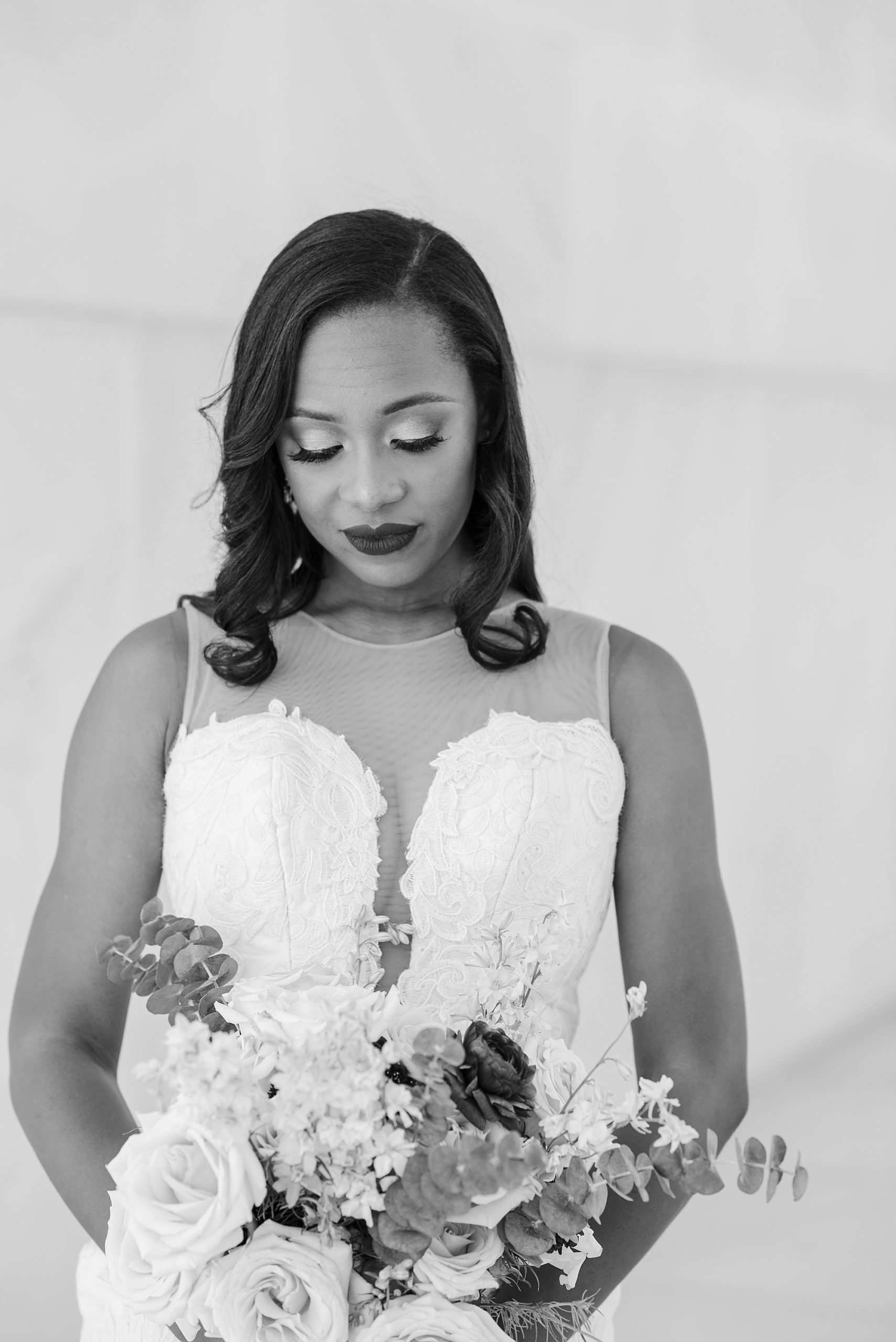 bride looks down at bouquet during Lincoln Memorial bridal portraits