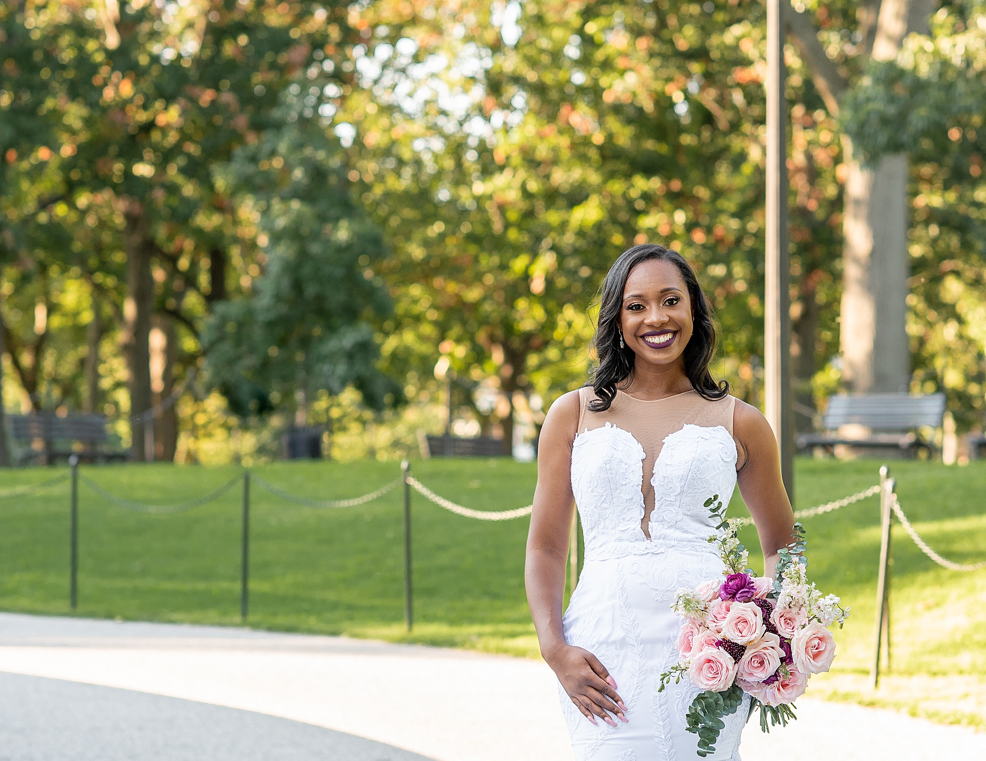 bride stands with flowers on hip during Lincoln Memorial bridal portraits