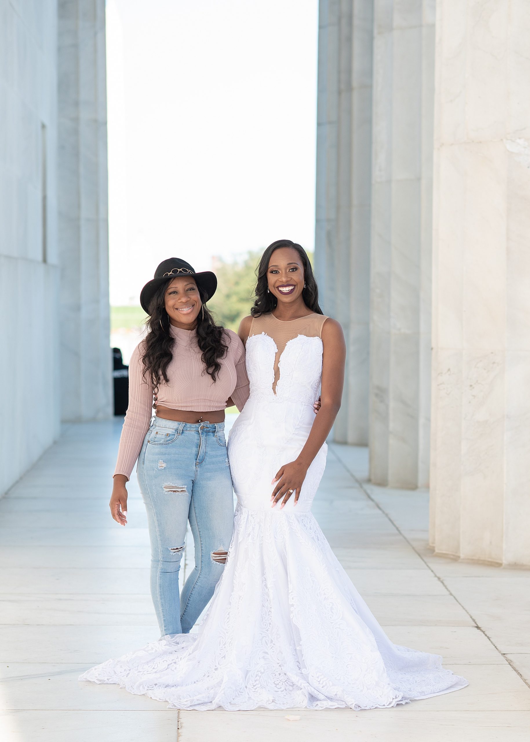 bride poses with friend at Lincoln Memorial