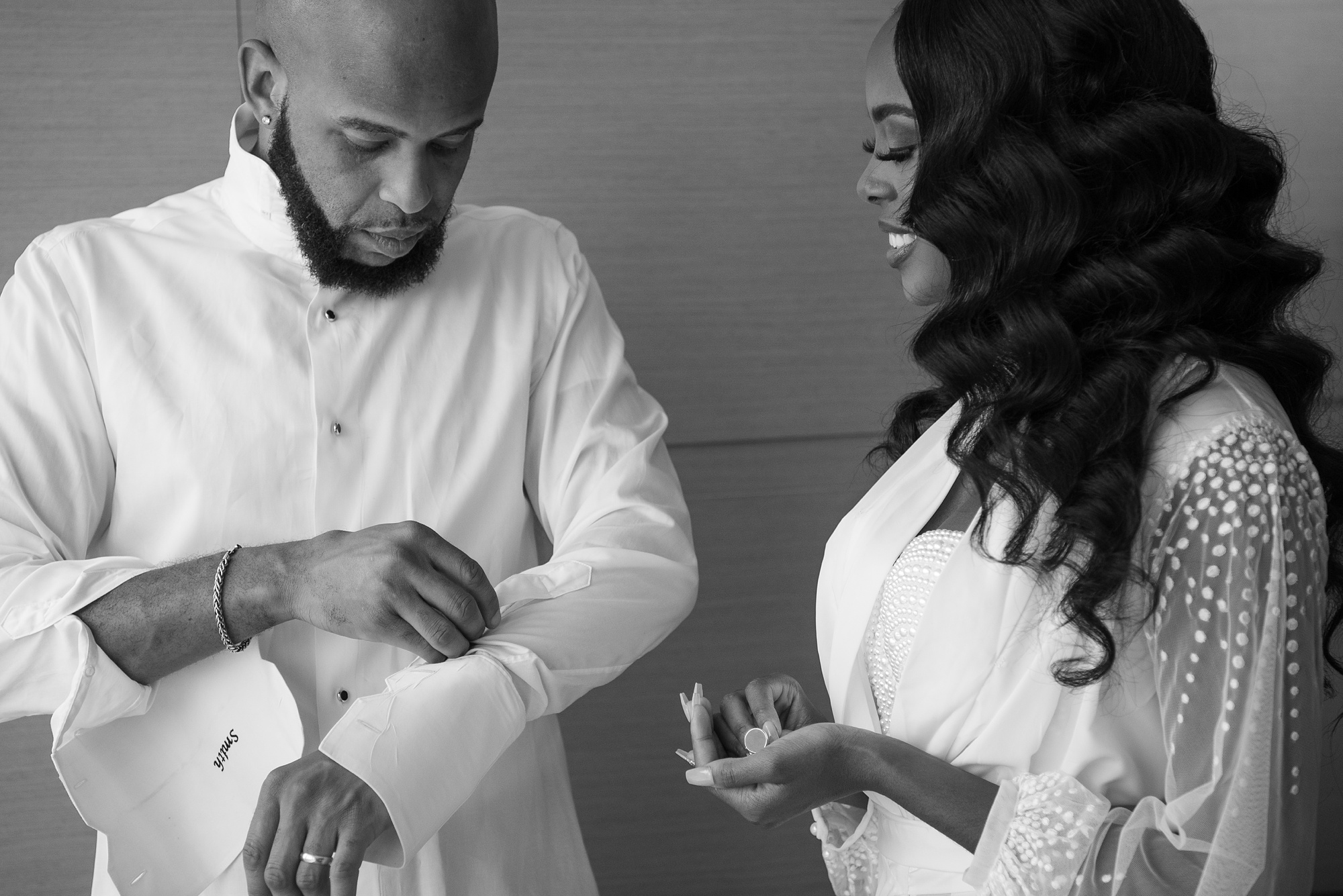 bride holds cufflinks for groom before DC wedding celebration 
